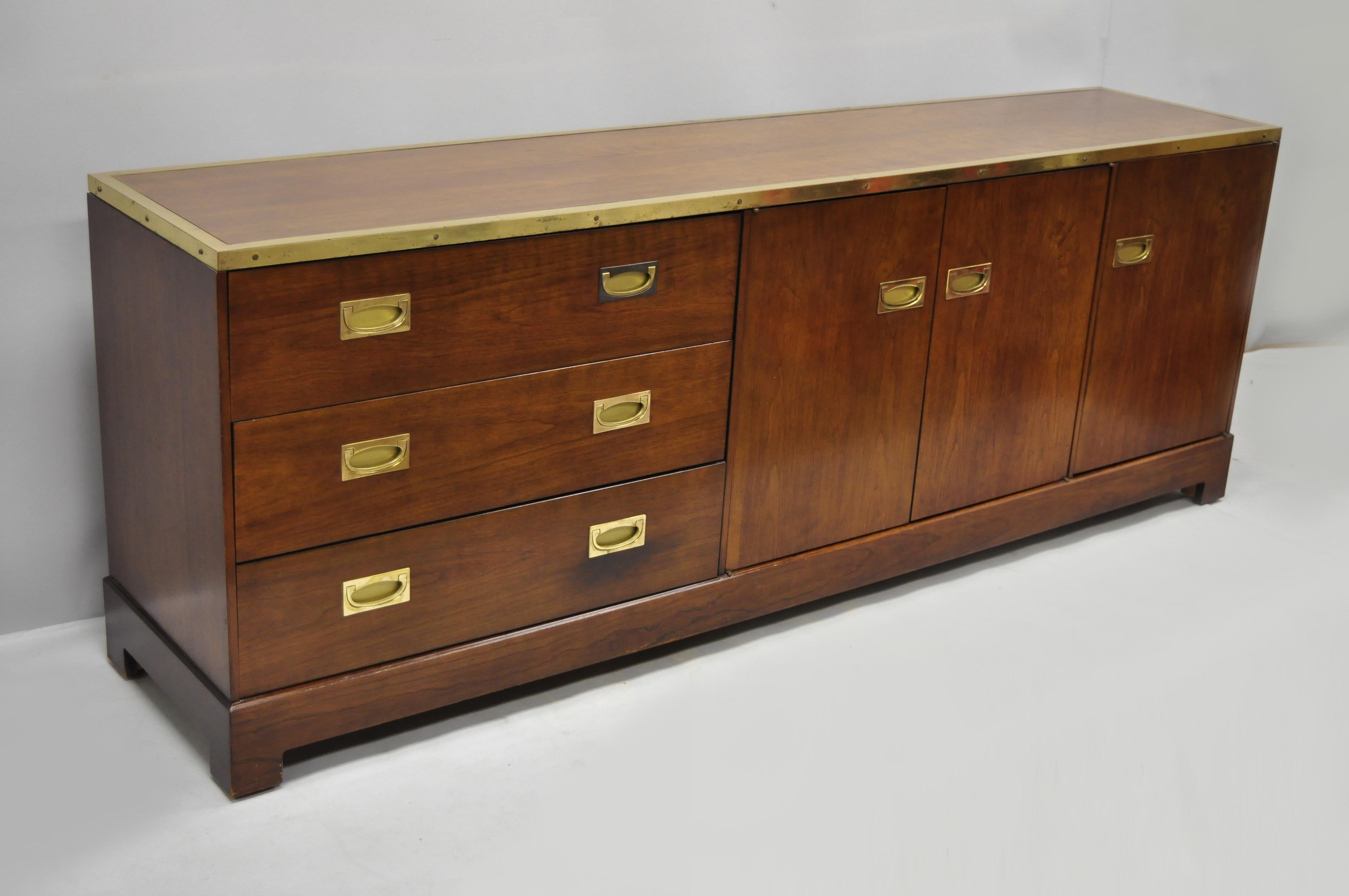 Late 20th century English campaign style cherry credenza cabinet with brass trim by Directional 