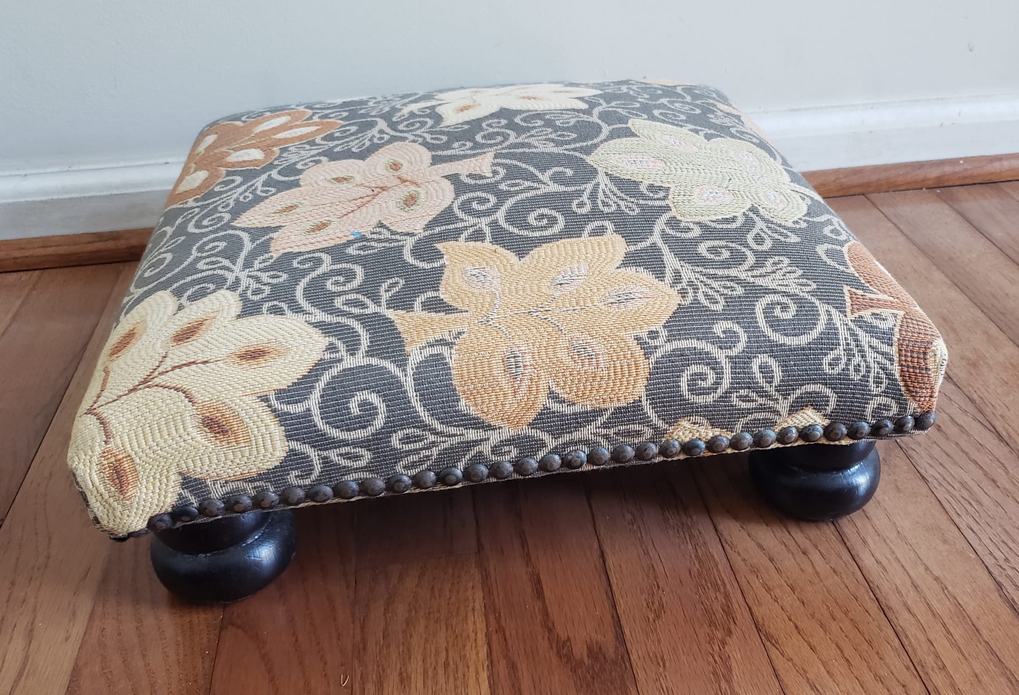 Late 20th Century Ebonized and Upholstered Footstool with NailHead Trims in great vintage condition.
Measures 14