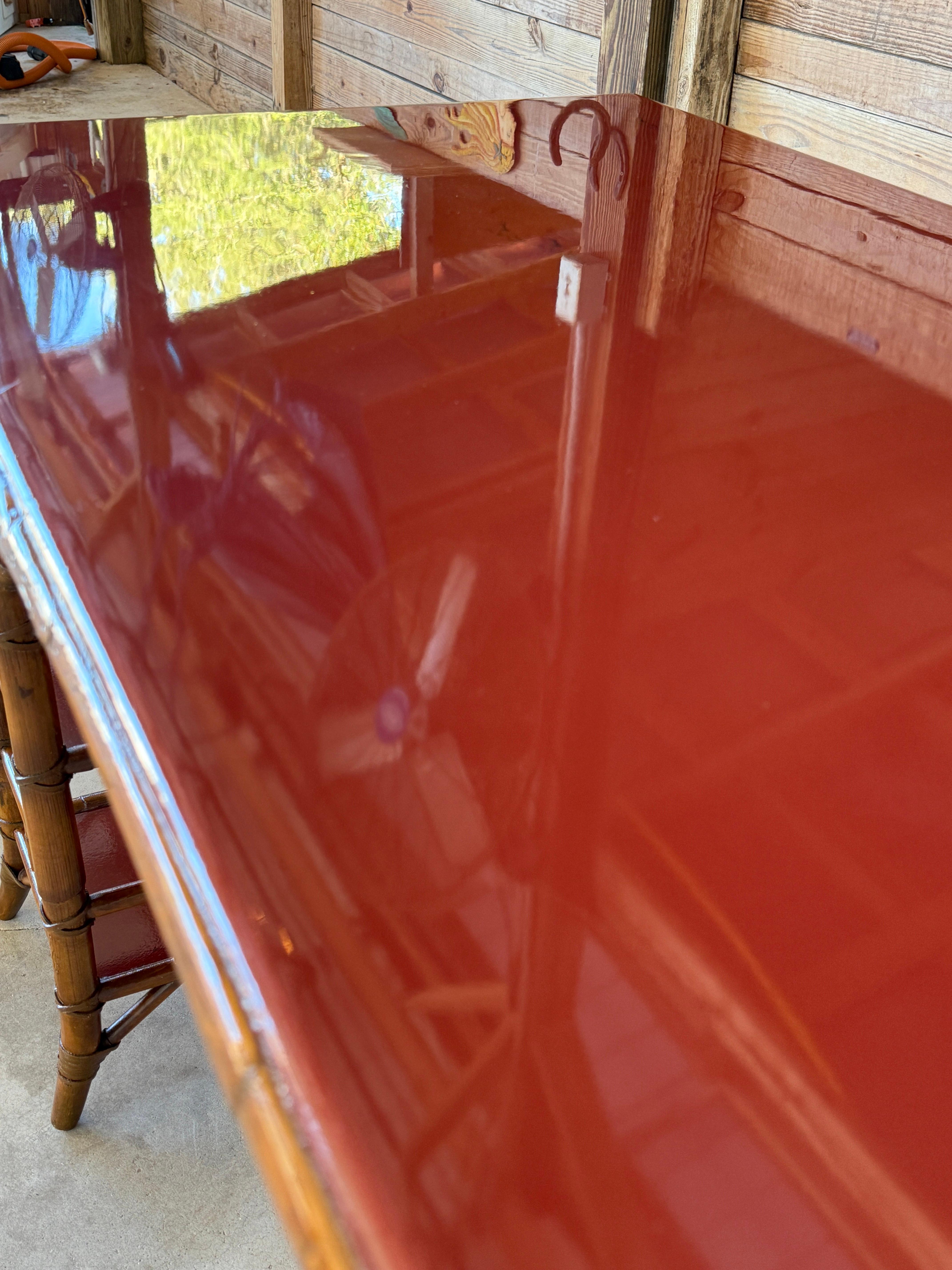 Eleganter Schreibtisch aus Bambusimitat von Baker Furniture aus dem späten 20. Jahrhundert mit der originalen roten Lackierung. Dieses wunderschön gestaltete Möbelstück verfügt über eine einzelne Schublade in der Mitte und offene Regale auf beiden