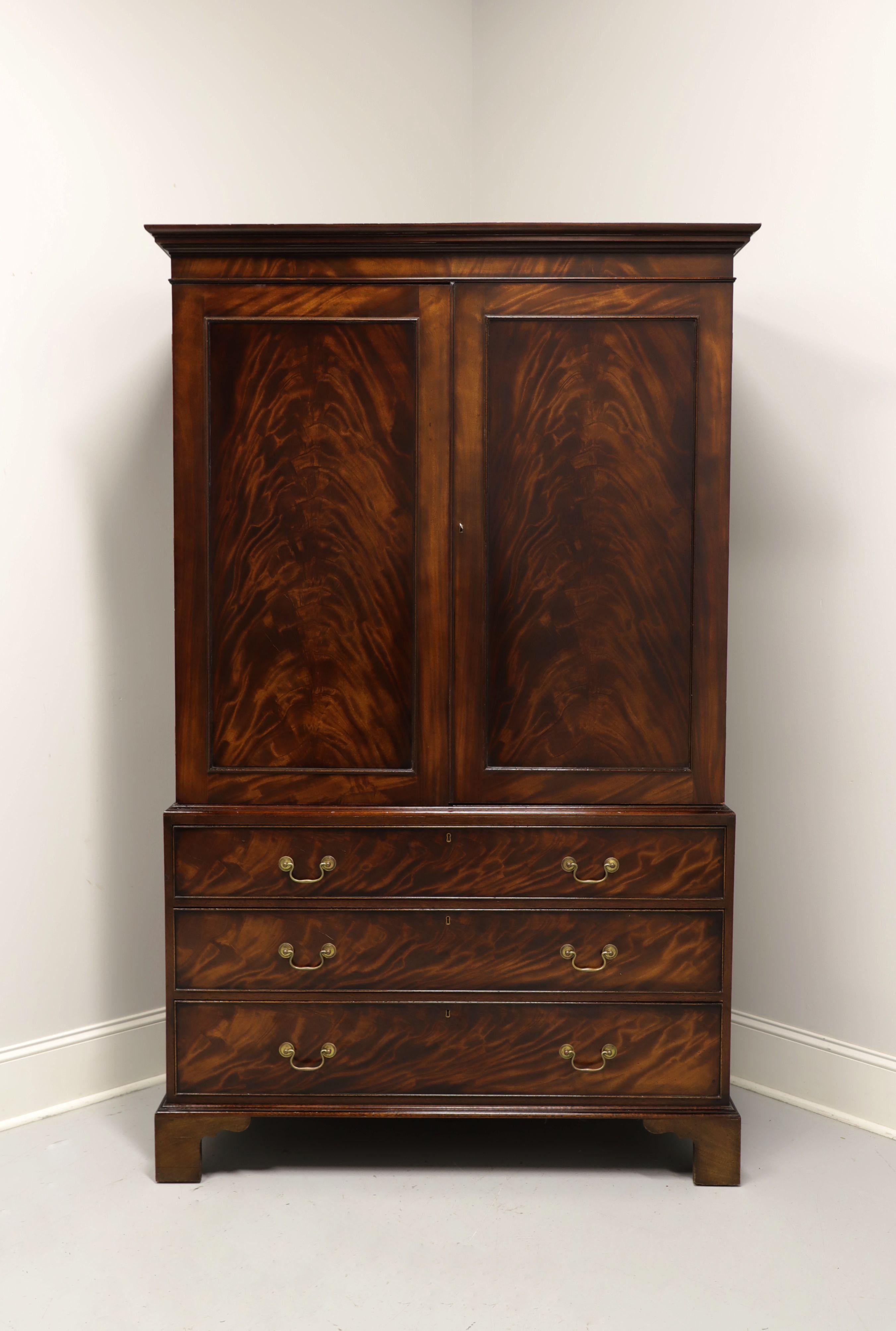 A Chippendale style linen press, unbranded, similar quality to Henredon and Hickory Chair. Flame mahogany with brass hardware, crown moulding at top and bracket feet. Upper area has two lockable solid fold open doors revealing storage with two