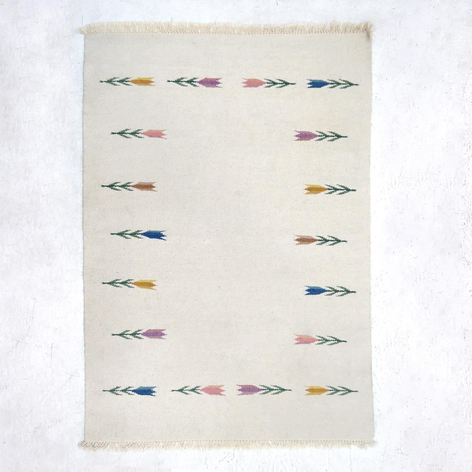 Wonderful light beige flat-weave rug with colorful stylized flower pattern.