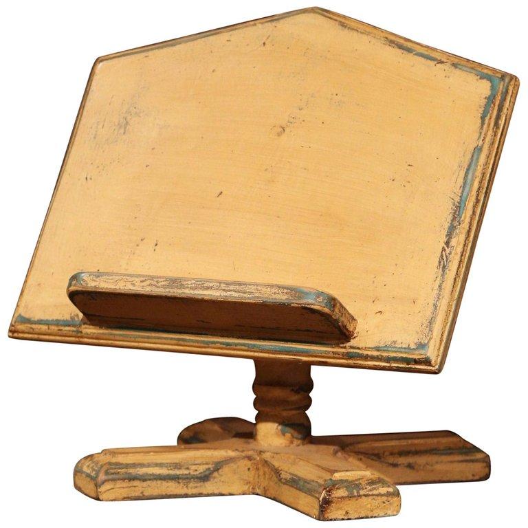 Place a cookbook on this stand for easy meal prep in the kitchen! Created in France, circa 1990, the Classic stand sits on a carved turned base ending with four feet, over a slant book holder. The free standing book holder is in excellent condition