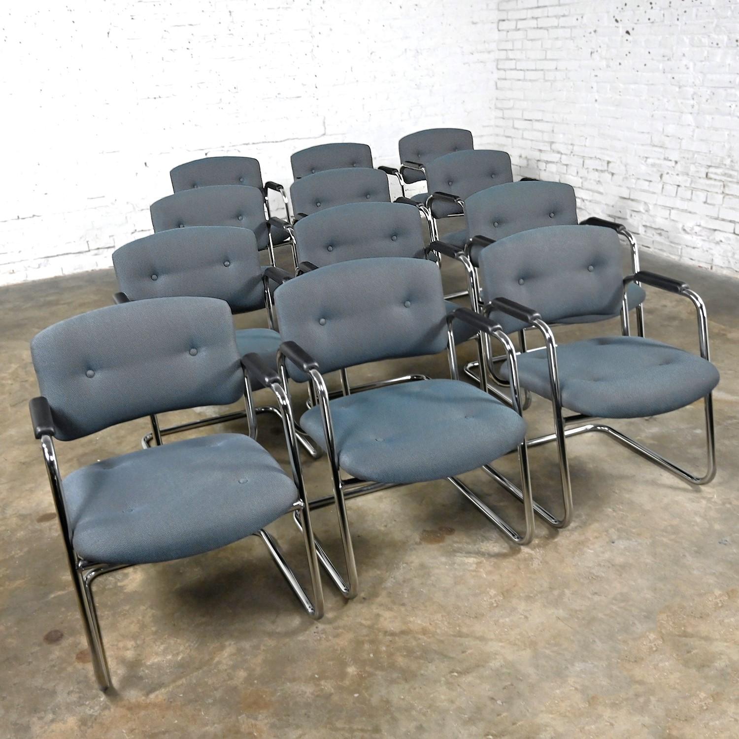 Awesome gray & chrome vintage cantilever chairs by United Chair Company in the style of Steelcase, set of 12. Comprised of a chrome cantilever frame, black plastic armrests, and their original gray tweed fabric with button details. This listing is