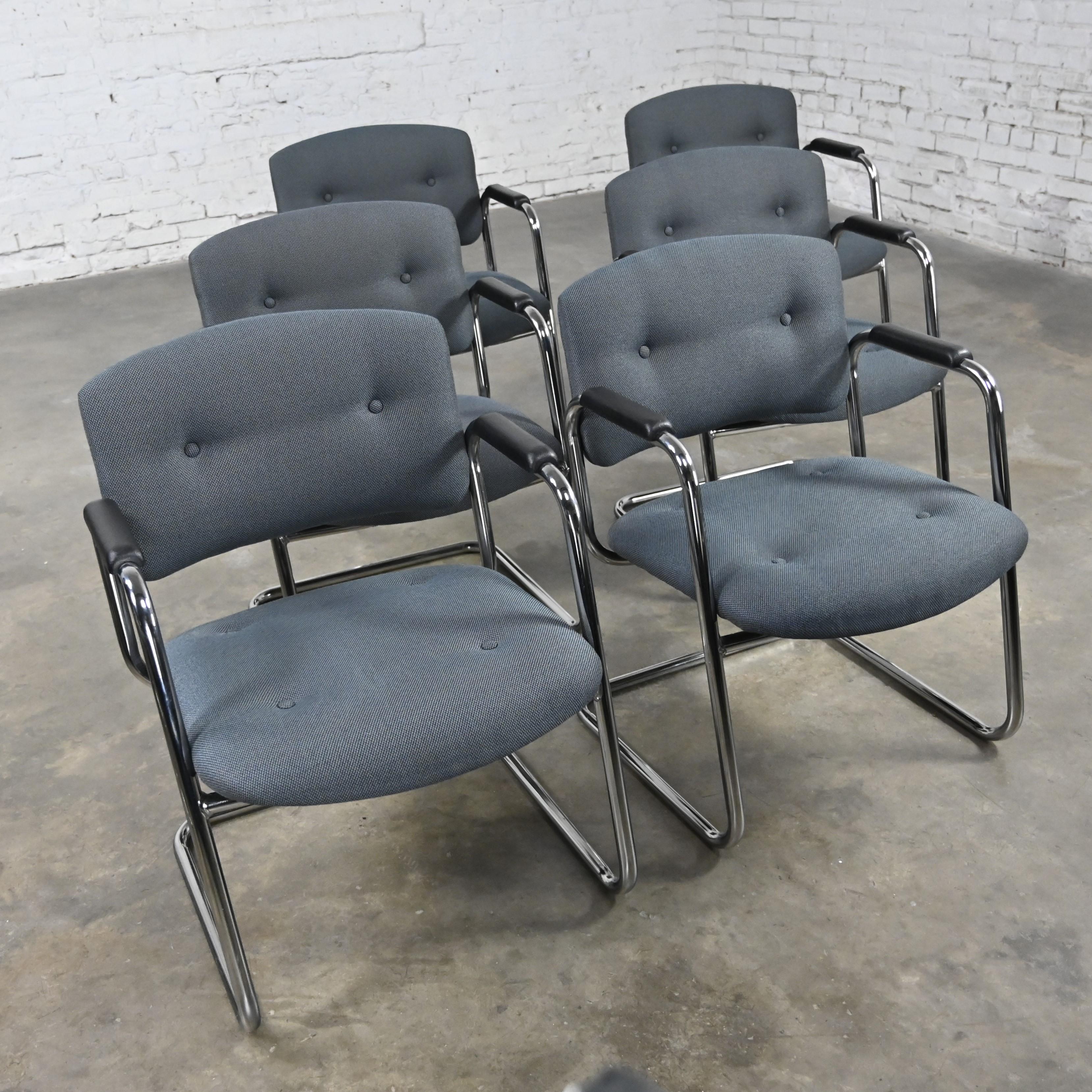 Awesome gray & chrome vintage cantilever chairs by United Chair Company in the style of Steelcase, set of 6. Comprised of a chrome cantilever frame, black plastic armrests, and their original gray tweed fabric with button details. This listing is