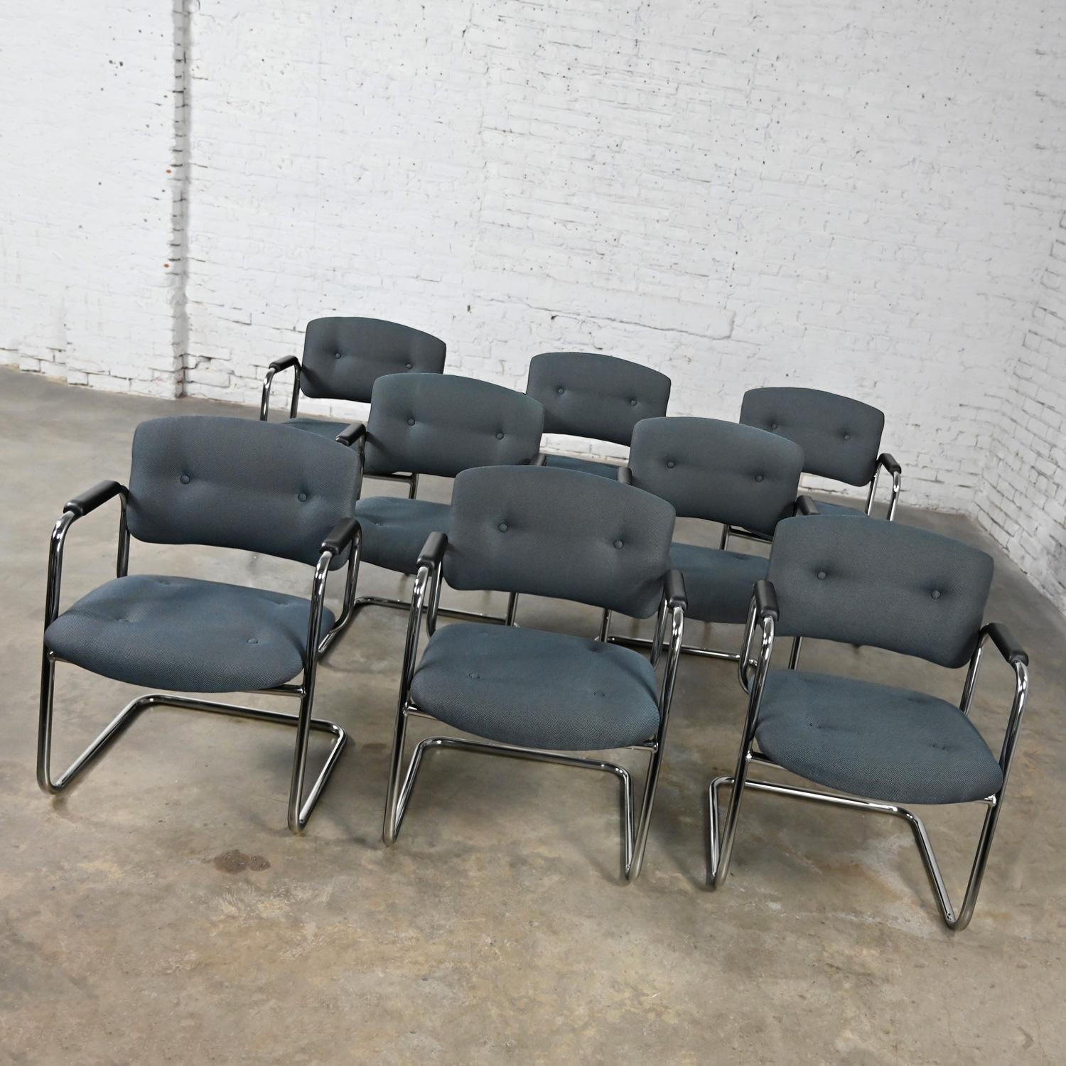 Awesome gray & chrome vintage cantilever chairs by United Chair Company in the style of Steelcase, set of 8. Comprised of a chrome cantilever frame, black plastic armrests, and their original gray tweed fabric with button details. This listing is