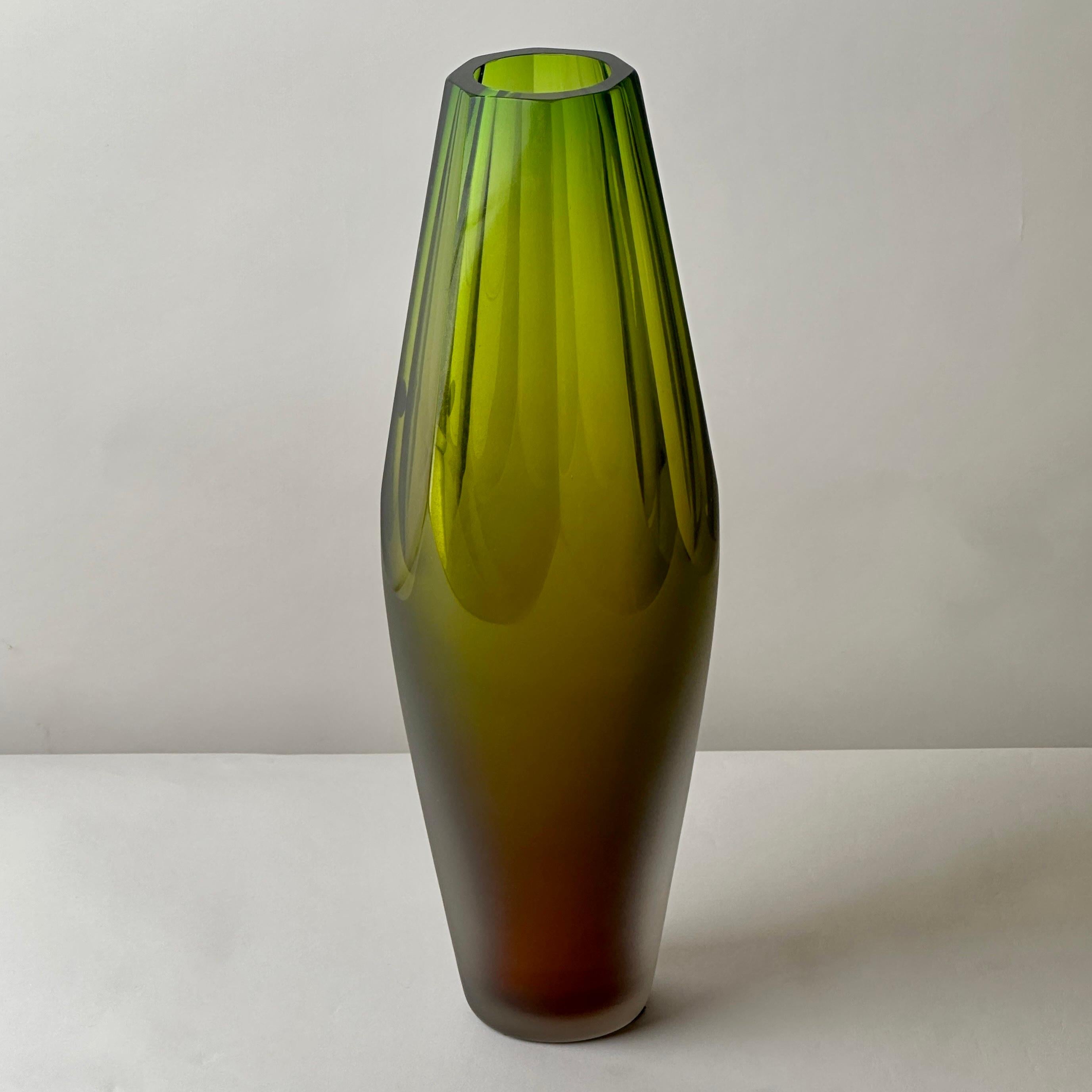 Modern and sleek hand faceted Murano glass vase with a reddish hue on the bottom of the vase. 
Hand signed by the Murano maker underneath the bottom.

About Vetreria Artistica Vivarini:

Vivarini's glassworks was established in 1967. The aim of the