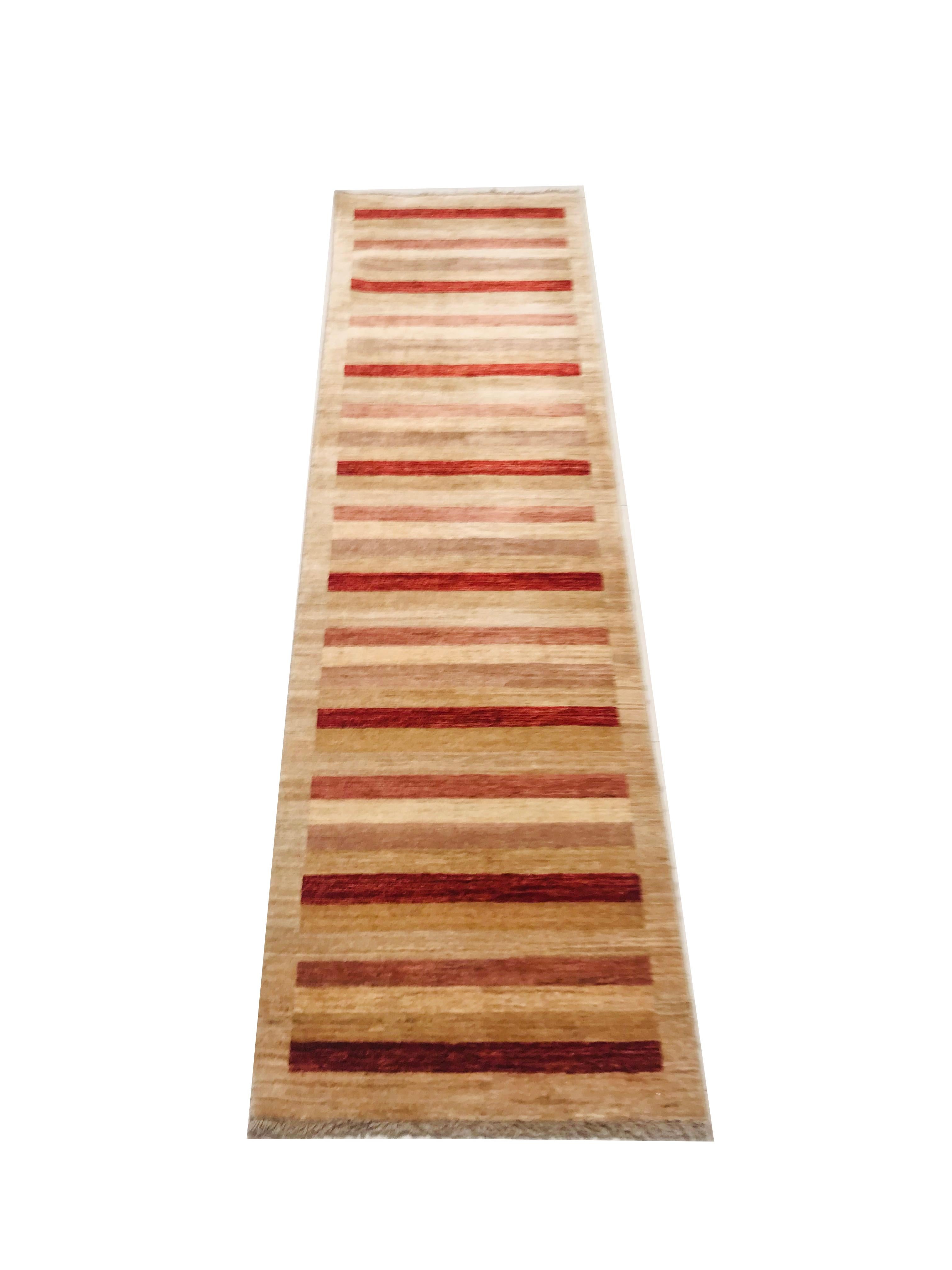 This Pakistan rug is from the 1980s, hand knotted with wool.
This set of carpet has straight lines and a combination of soft colors such as red, yellow and beige that makes it a perfect piece to decorate a corner of our home.