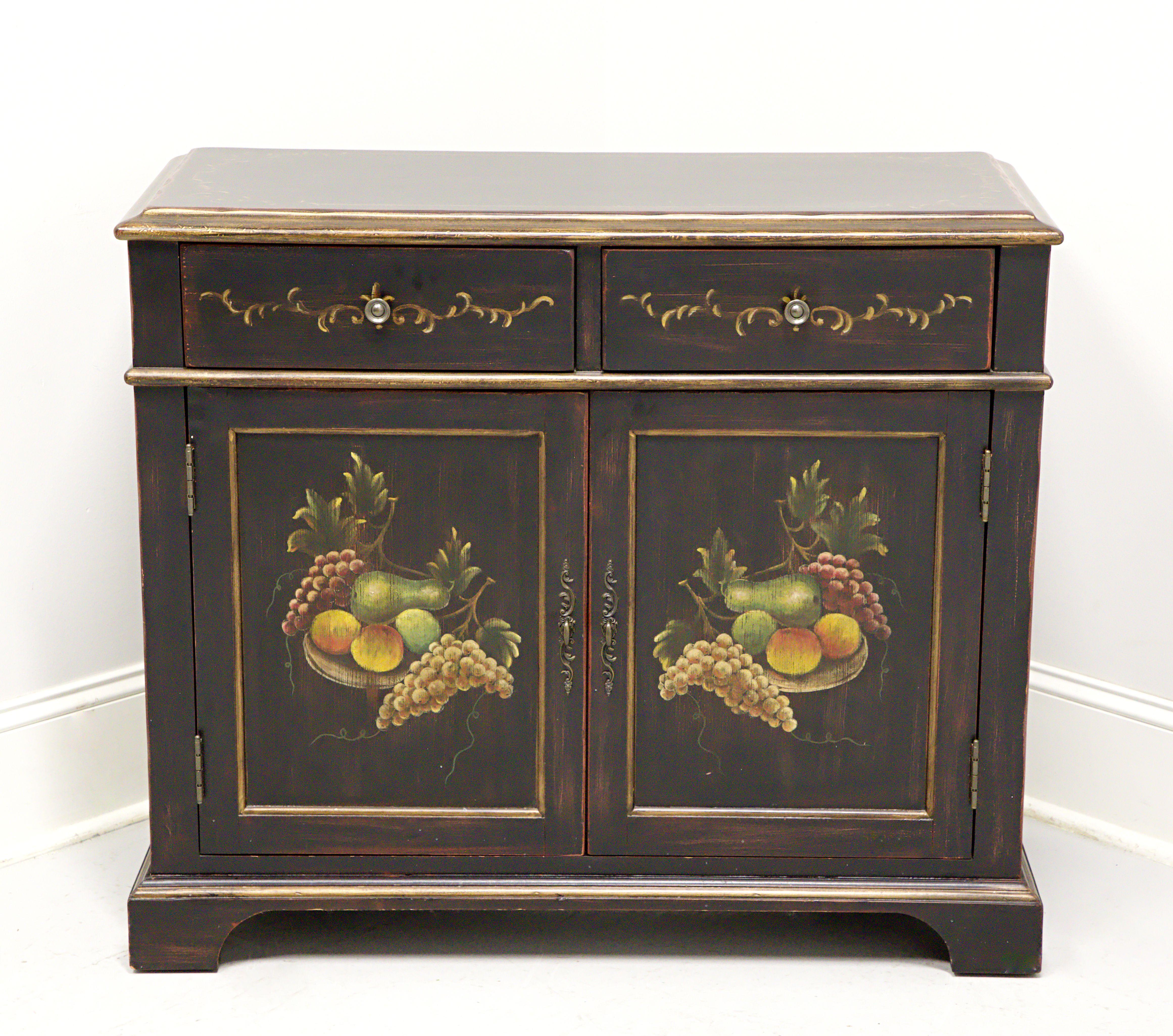 A French Country style console cabinet, unbranded, similar quality to Pulaski or Thomasville. Solid hardwood painted black with distressing, brass hardware, hand painted gold ornamentation to top, drawers & sides, hand painted fruit motif to door