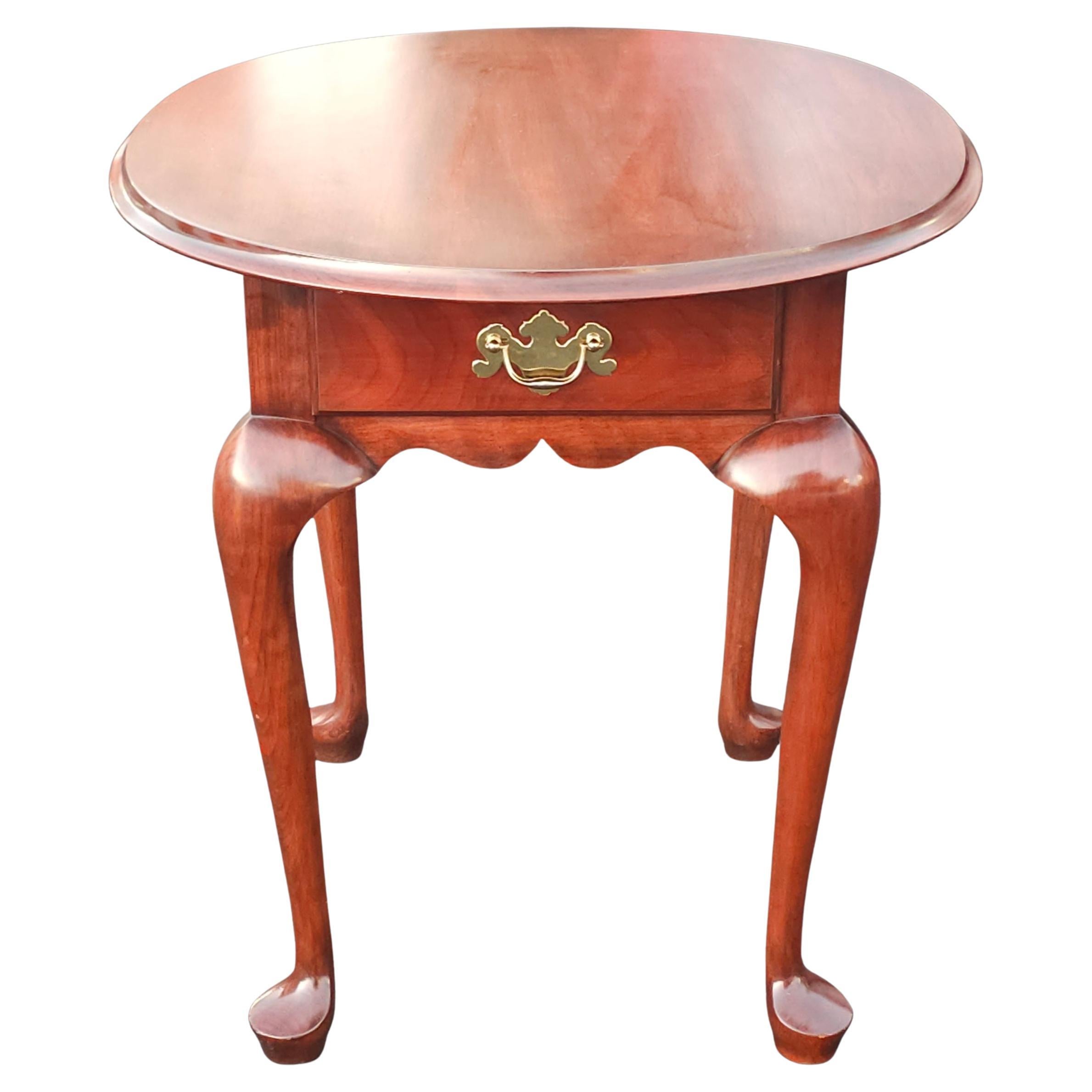 A Late 20th Century Henkle Harris Wild Black Cherry Queen Anne Style Oval Side Table.
Measures 24