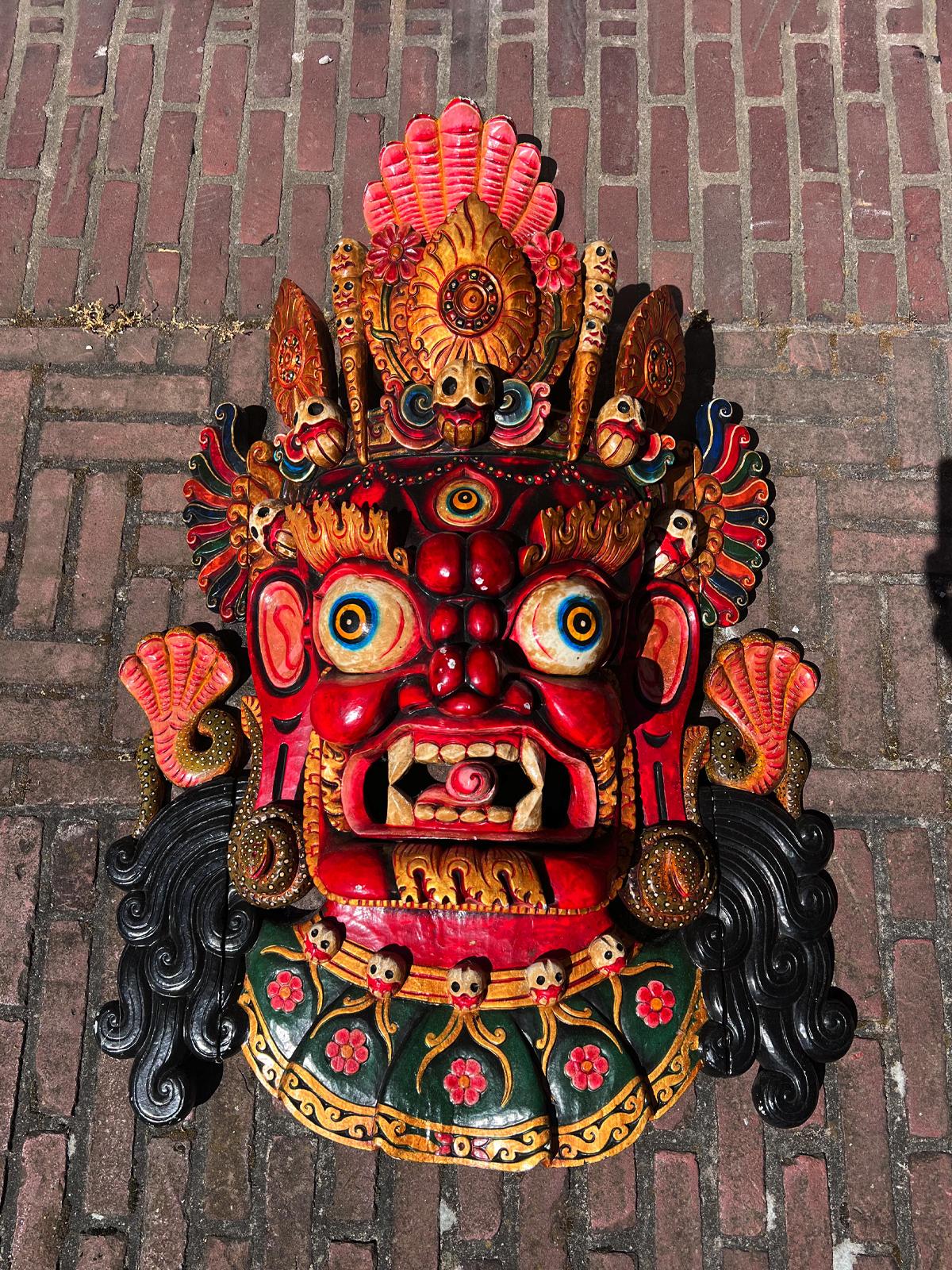 Discover this high-quality wooden Mahakala face mask from Nepal, a commanding late 20th-century piece that showcases traditional Himalayan artistry. Expertly carved from wood, it measures 118 cm high and 79 cm wide, with an impressive weight of