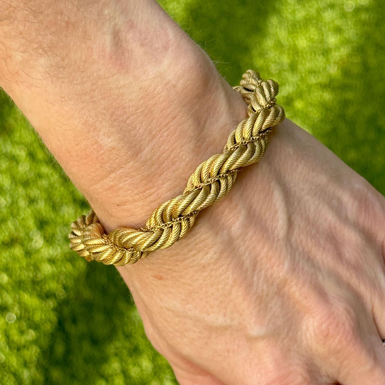 This exquisite Italian gold rope bracelet is a stunning piece crafted from 18k yellow gold, showcasing a beautifully twisted rope design that exudes sophistication and charm. Measuring 11mm wide, the bracelet is both bold and elegant, making it a