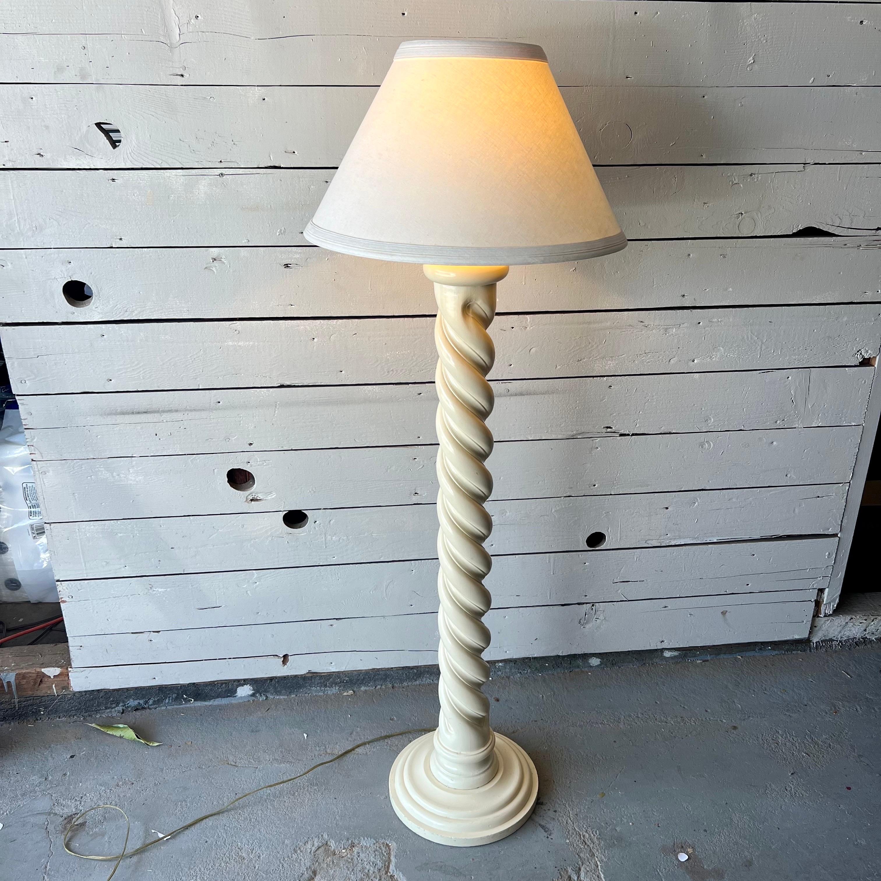 This vintage Italian lacquered spiral lamp, carved from wood, features a sleek spiral design. Its lacquered finish adds shine, highlighting the craftsmanship evident in its curves. This lamp’s timeless appeal makes it a standout piece in any room.