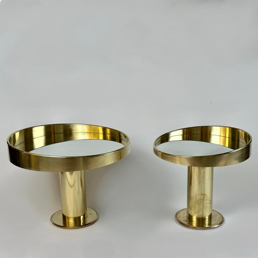 Two pairs of Space Age round brass side tables (one small and one big for each pair) / night stands with a silver mirror top. 
Size: 55 Diameter. x 53 Height cm. + 70 Diameter. x 53 Height cm.