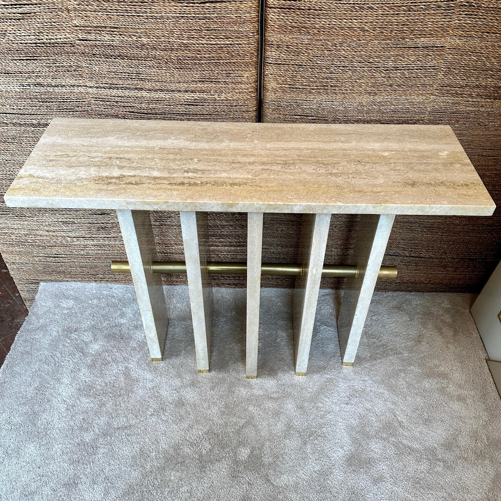 Stunning Italian travertine & brass console adapt for any modern entrance or living room. The console table stone top is resting on the five monolithic travertine legs that are kept together from a brass cylindric bar. Each stone leg has a brass