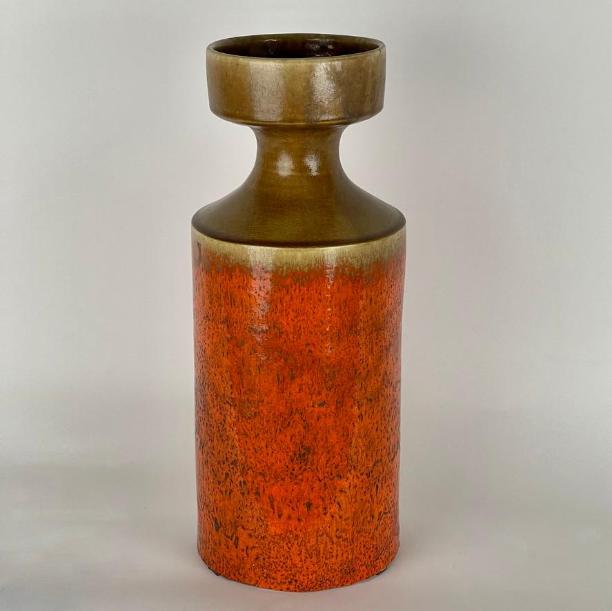 Orange & ocher glazed ceramic vase, artist-signed Gambone Italy at base.

About the Artist:
Bruno Gambone (1936 - 2021) is an Italian ceramist and the son of Guido Gambone, one of Italy's most prominend ceramists in the 1950 and 1960s. Bruno took