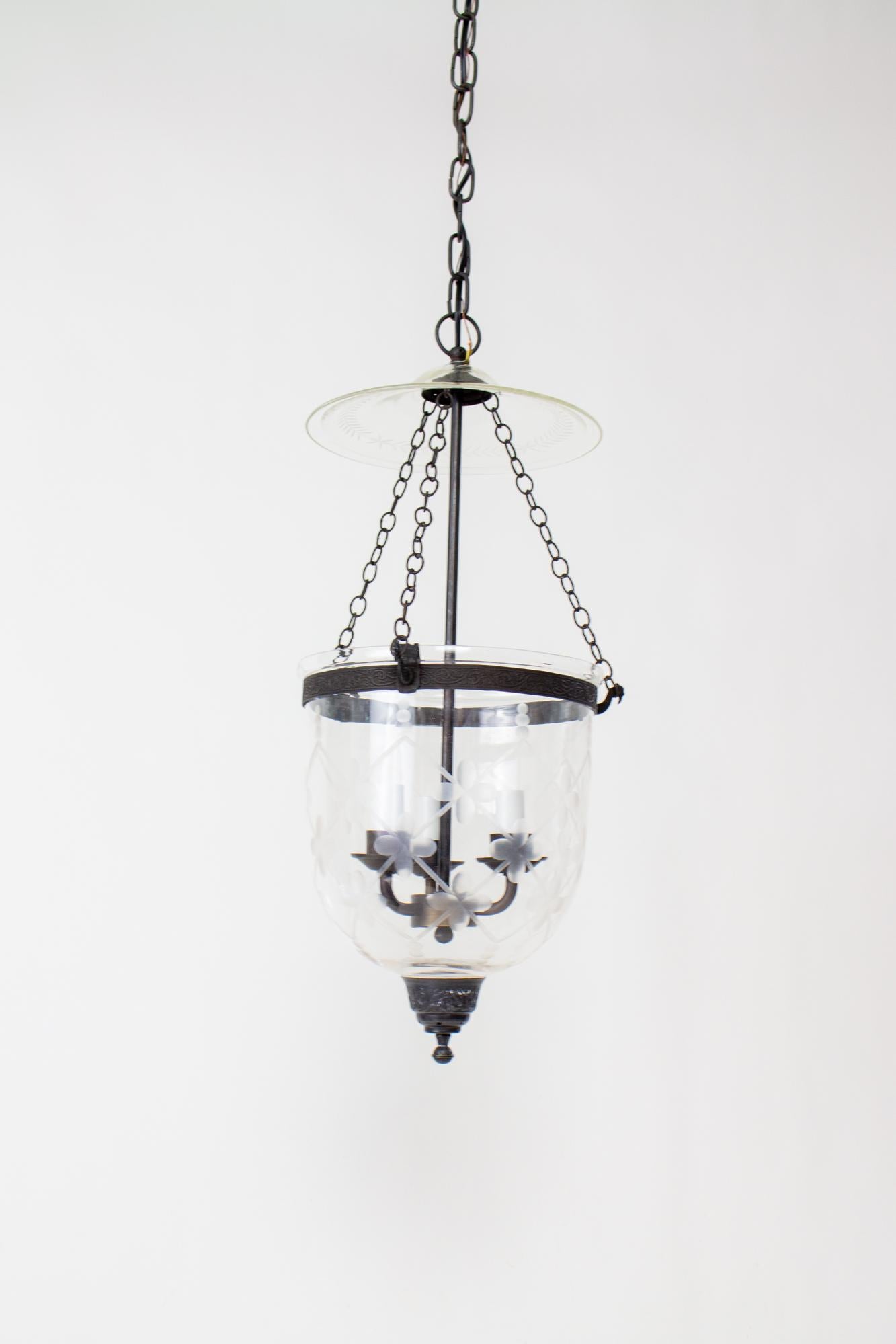 Clear lattice cut glass bell jar with darkened brass finish. Bell jar lanterns first reached popularity in colonial India and due to their lingering popularity, production has continued to the present. Made from delicately blown clear glass with a