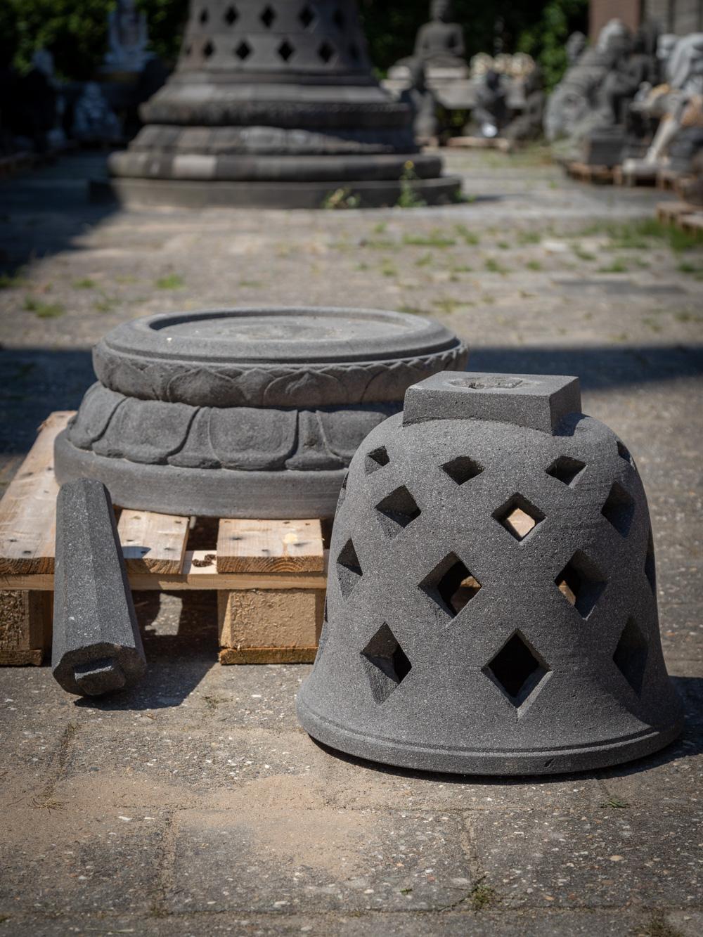 The lavastone Stupa from Indonesia is a remarkable piece that embodies the spiritual and cultural traditions of the region. Crafted from lavastone, this Stupa stands tall at 93 cm in height and has a diameter of 72 cm. The use of lavastone adds a