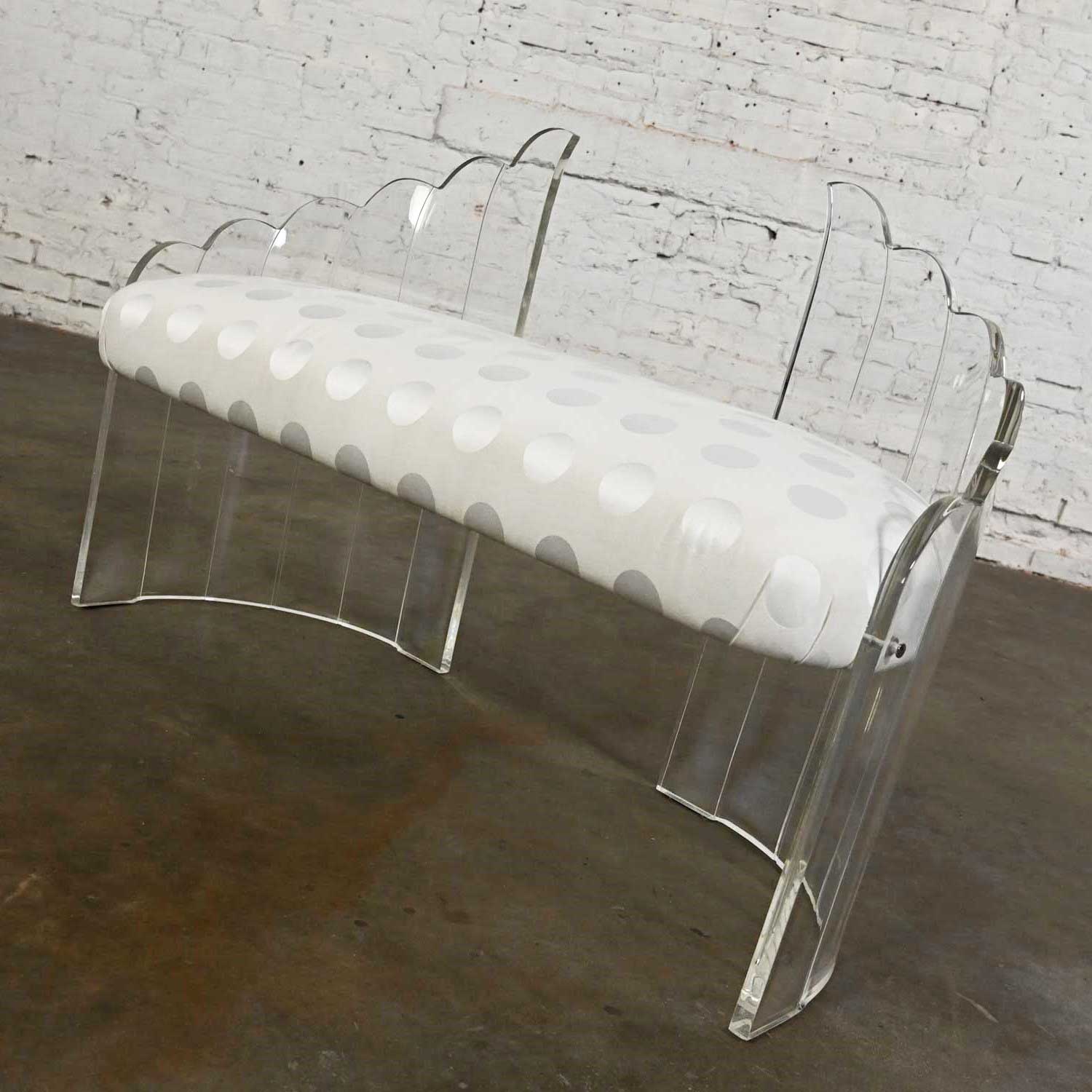 Stunning vintage lucite Art Deco Hollywood Regency sculptural wing bench with a white polka dot jacquard fabric. Beautiful condition, keeping in mind that this is vintage and not new so will have signs of use and wear. Fabric has been cleaned and