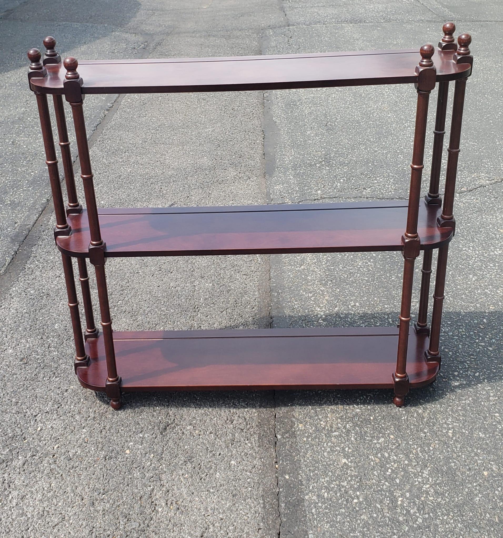 Late 20th Century three tier Mahogany finish hanging wall shelves in very good vintage condition. Measures 31.75