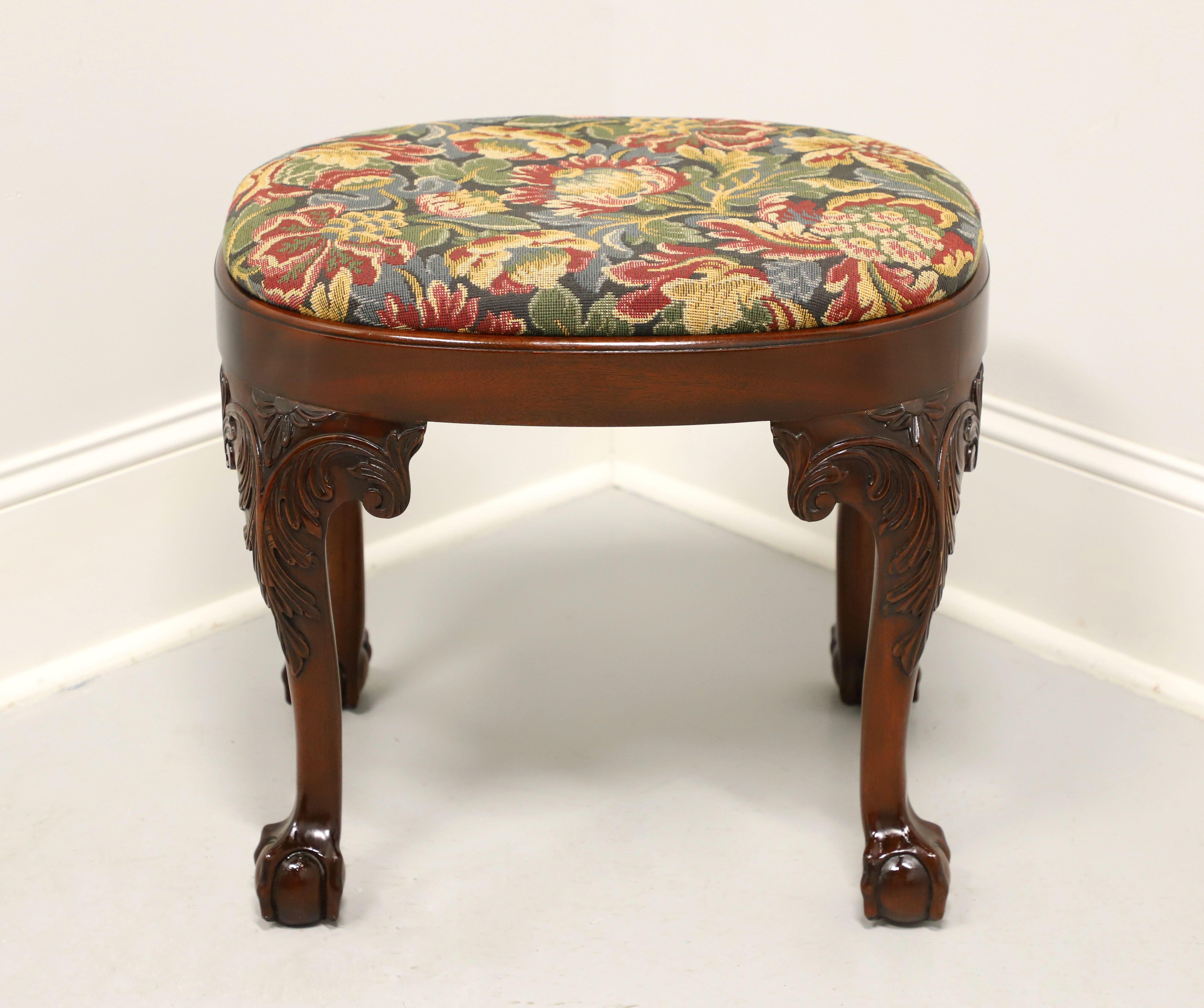A Chippendale style bench footstool, unbranded, made for high end furniture dealer, Colony Furniture of Charlotte, North Carolina, USA, under their private label. Likely made for them by Century Furniture. Solid mahogany, oval shape, a multi-color