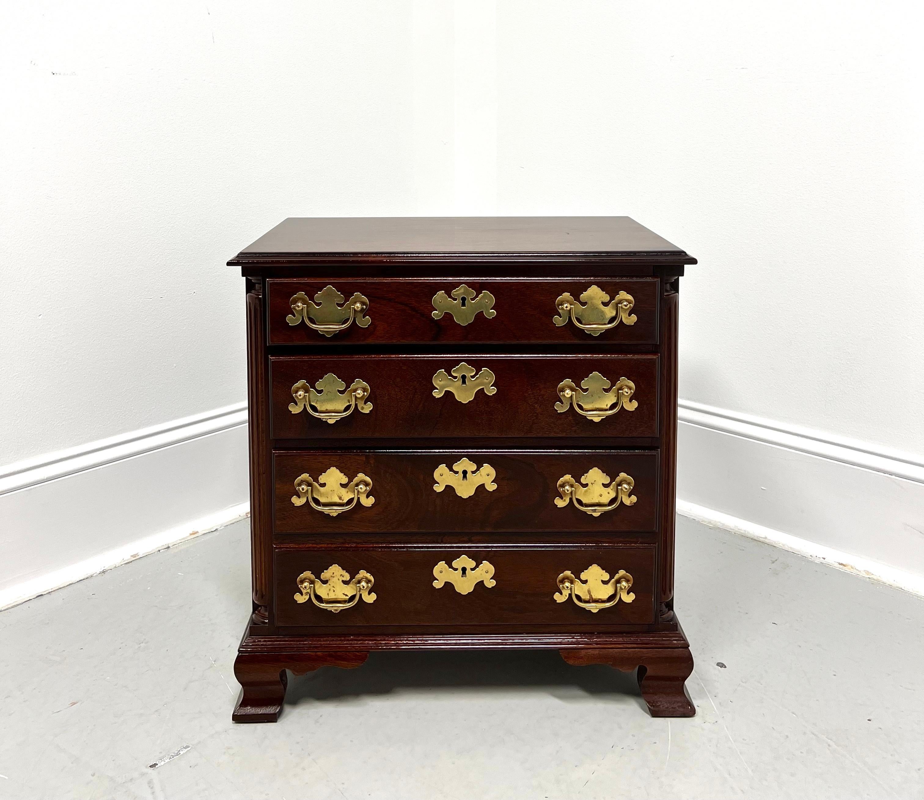 A Chippendale style chairside chest, unbranded, possibly by Madison Square or similar. Mahogany with brass hardware, ogee edge to the top, fluted columns to the front sides, fully finished on all sides, and ogee bracket feet. Features three drawers
