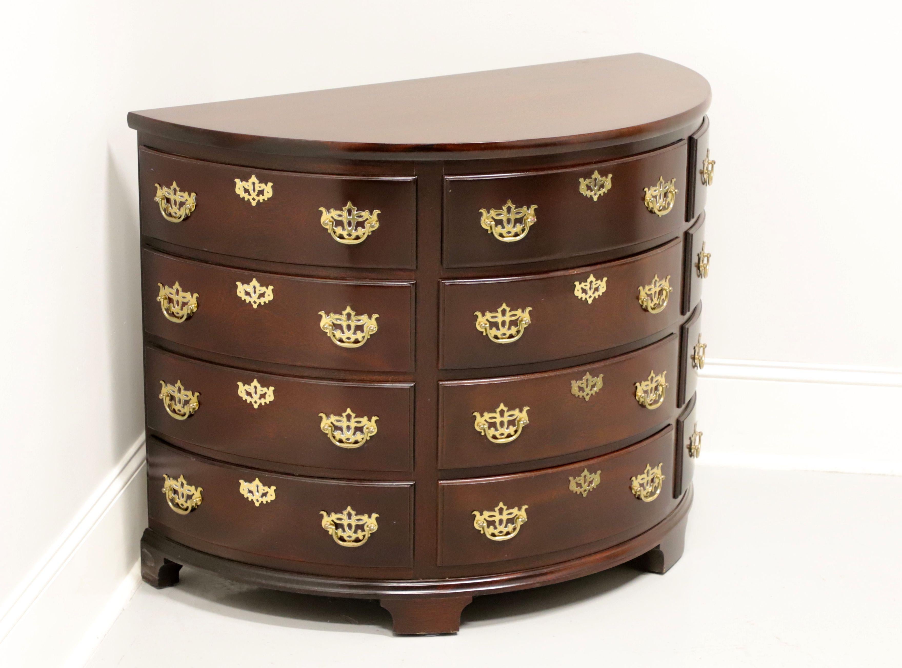 A Chippendale style demilune commode chest by Madison Square. Solid mahogany with brass hardware, half moon shape and bracket feet. Features four center drawers with faux keyhole escutcheons flanked by four faux drawers on each side with faux