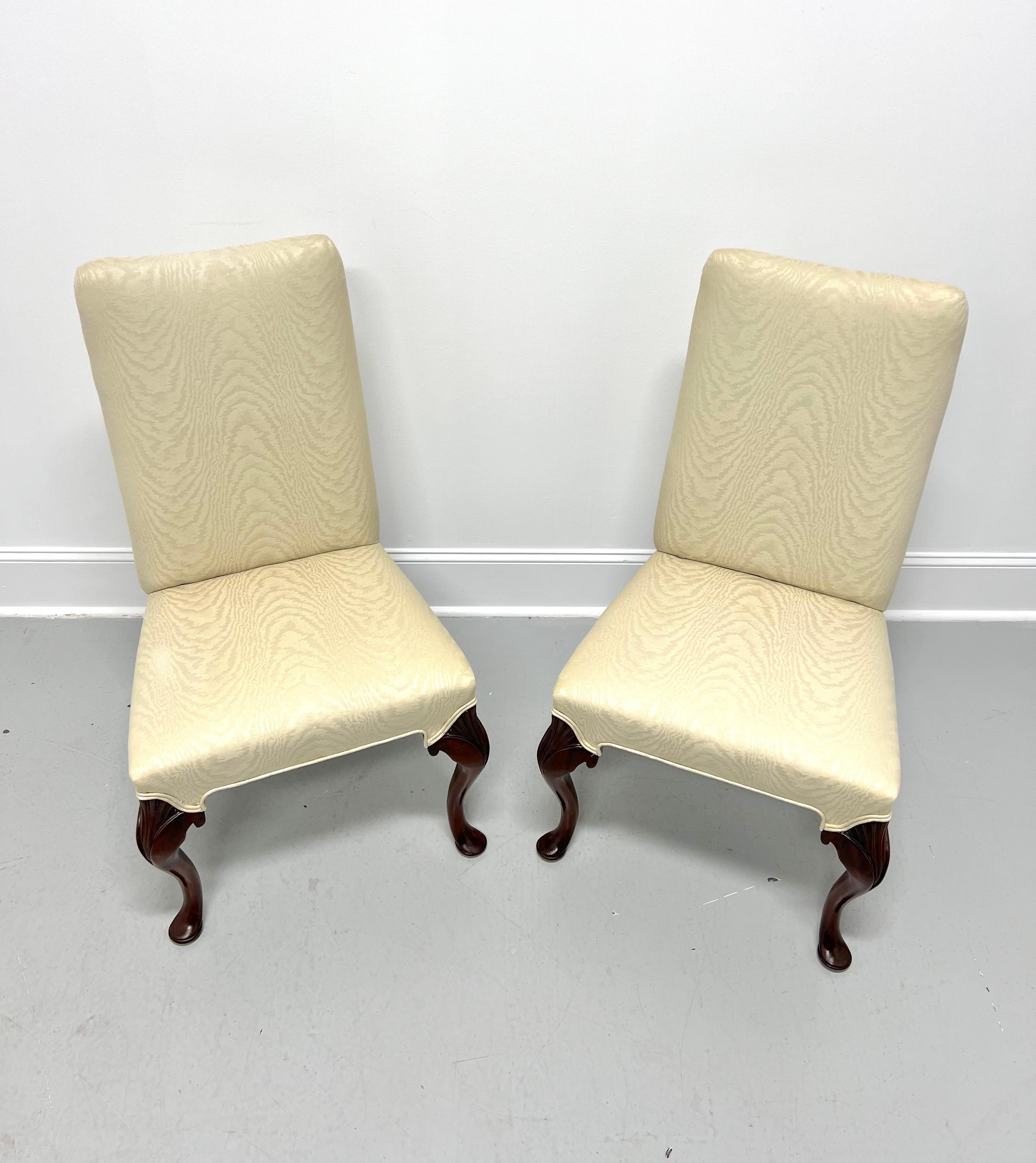 A pair of French Provincial style Parsons chairs, unbranded, similar in quality to Hickory Chair or John Widdicomb. Mahogany frames with high backs, carved knees, cabriole legs, and pad feet. Upholstered in a cream color flame pattern fabric. Likely