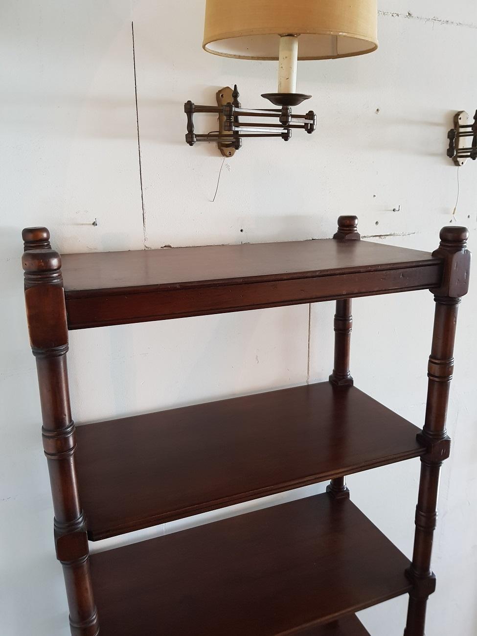Late 20th century mahogany open étagère with six shelves, it can be stand free because it's finished all around. A good looking item to use as a room divider for displaying your lovely items. It has some wear on the shelves consistent by age and