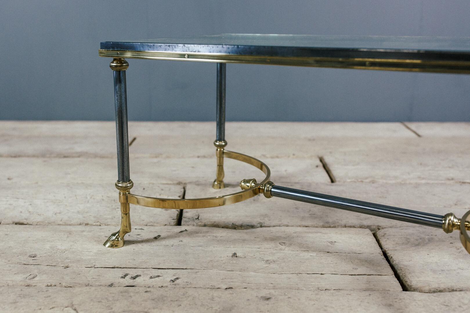 Superb quality Maison Charles goat hoof brass and steel coffee table, original glass surface. Repolished to its original high standard. As expected minor imperfections (scratches not chips) to both glass and steel.

     