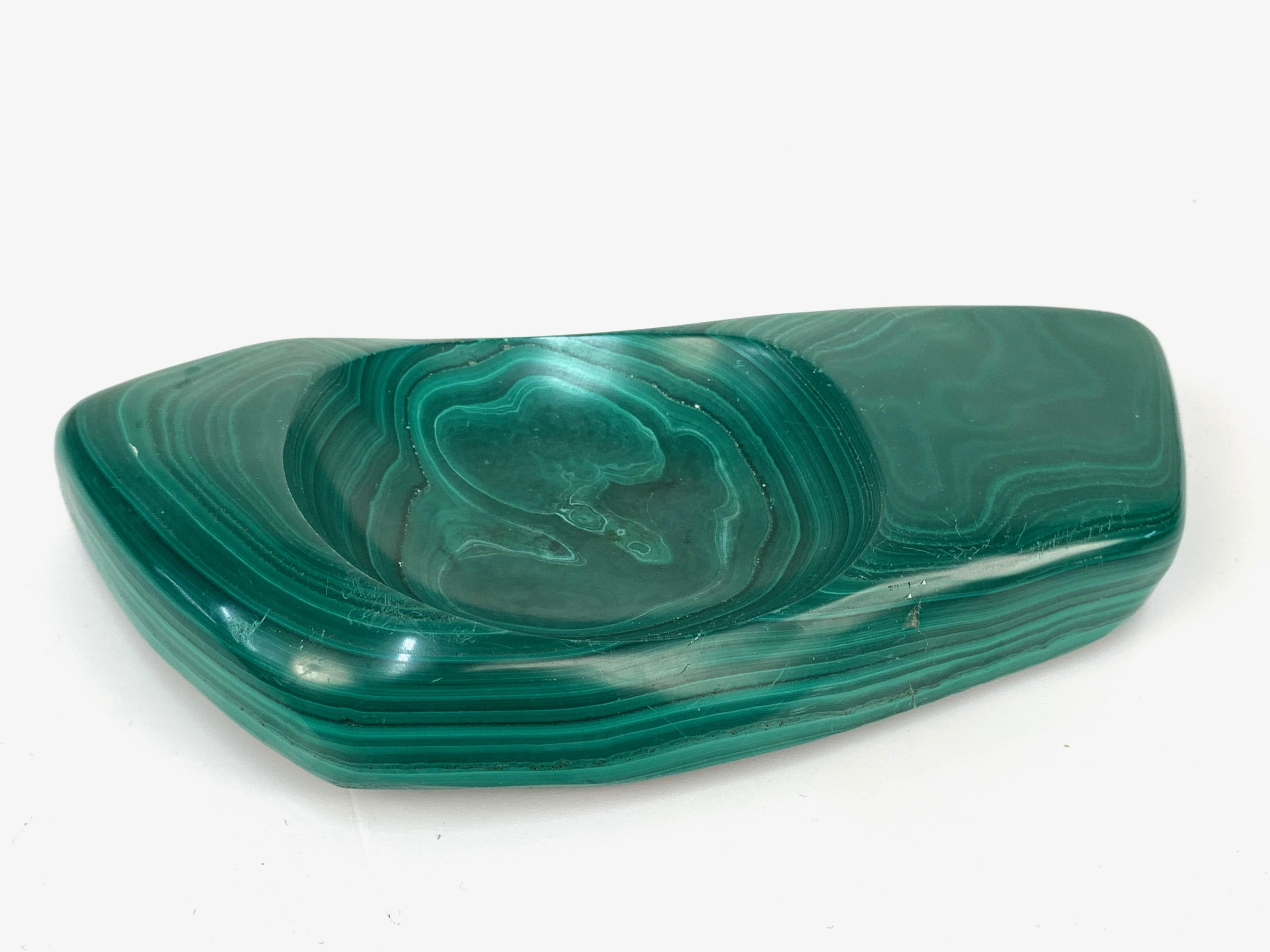 Elegant midcentury ashtray in green malachite marble.

The item is an Italian ashtray with an iconic midcentury design with an irregular shape and a round cigarette holder.

A wonderful ashtray that will enrich a midcentury project.