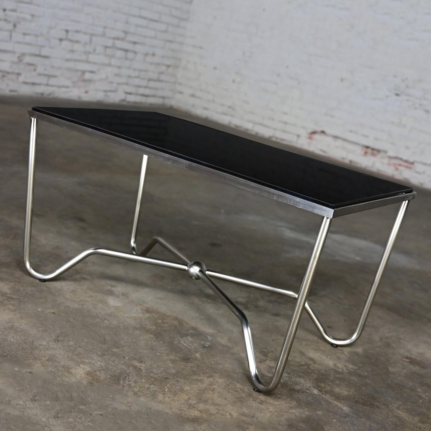 Handsome vintage Modern brushed steel tube coffee table with a removeable rectangular black glass top insert. Beautiful condition, keeping in mind that this is vintage and not new so will have signs of use and wear even if it has been refinished or