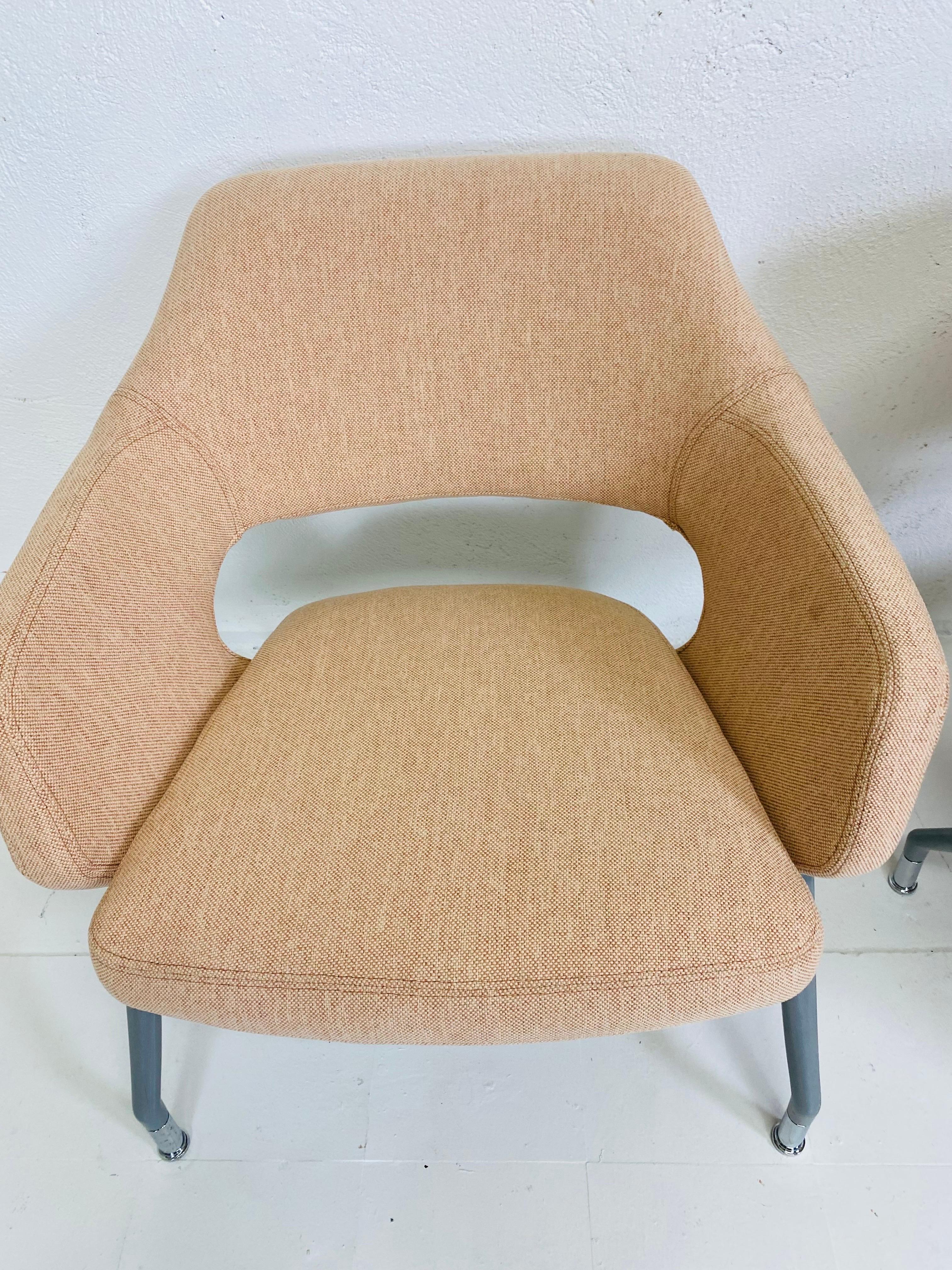 This is a pair of 21st Century modernist club chairs by Arcadia furniture Company. These chairs are upholstered in a neutral soft pale pink cotton duct. These chairs have modern steel frames with a gray finish to the surface. These modern neutral