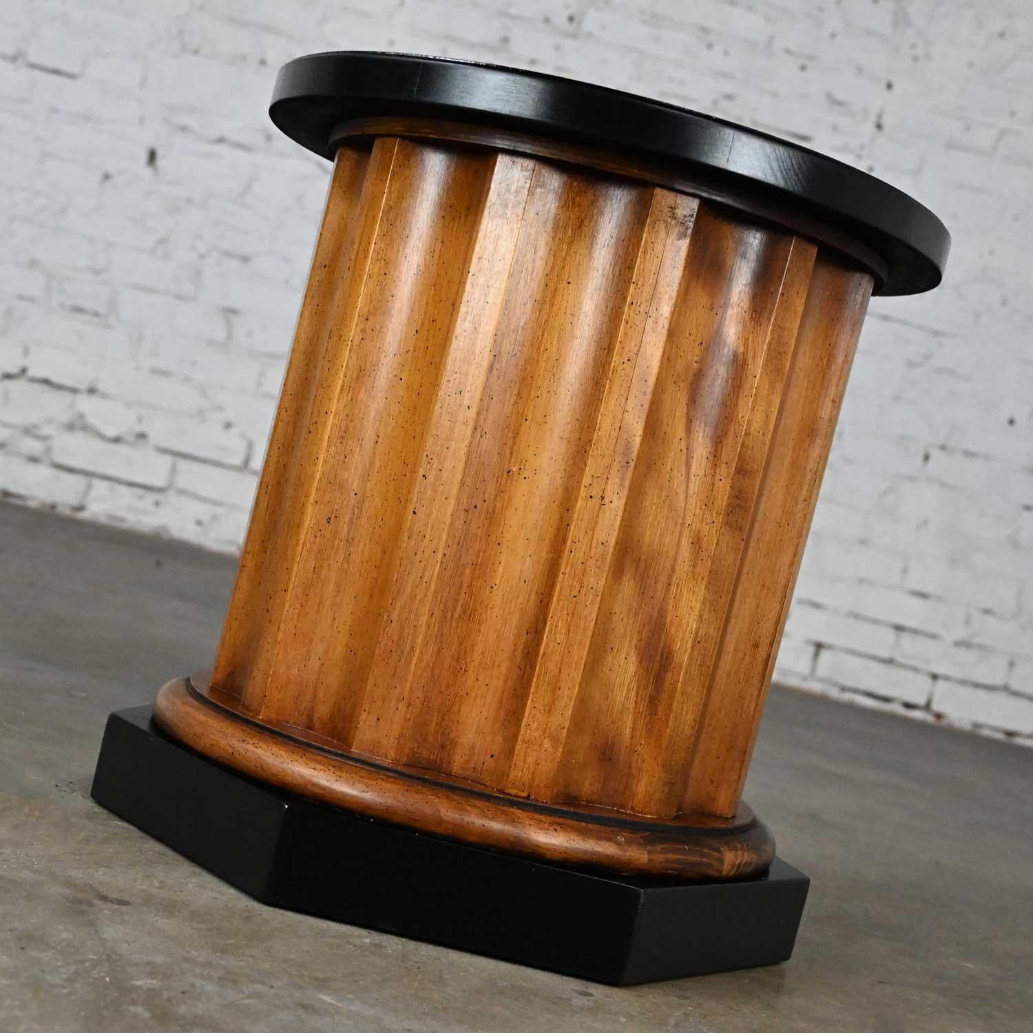 Handsome vintage neoclassic Revival walnut toned wood column end table with black accents. Beautiful condition, keeping in mind that this is vintage and not new so will have signs of use and wear. The round tabletop and octagon base have been given