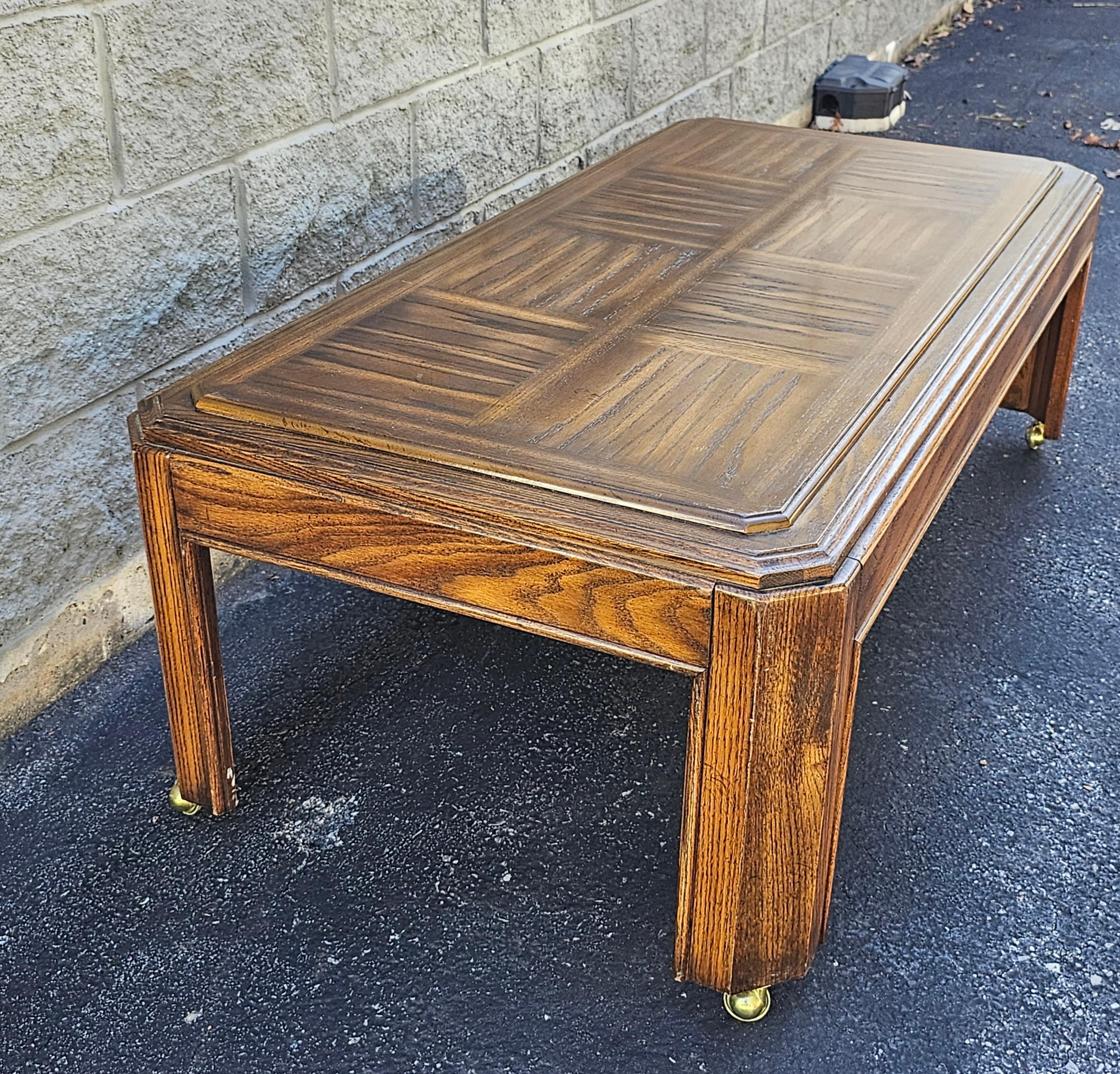 A late 20th Century Oak Parquet coffee table on casters in great vintage condition.
Measures 52