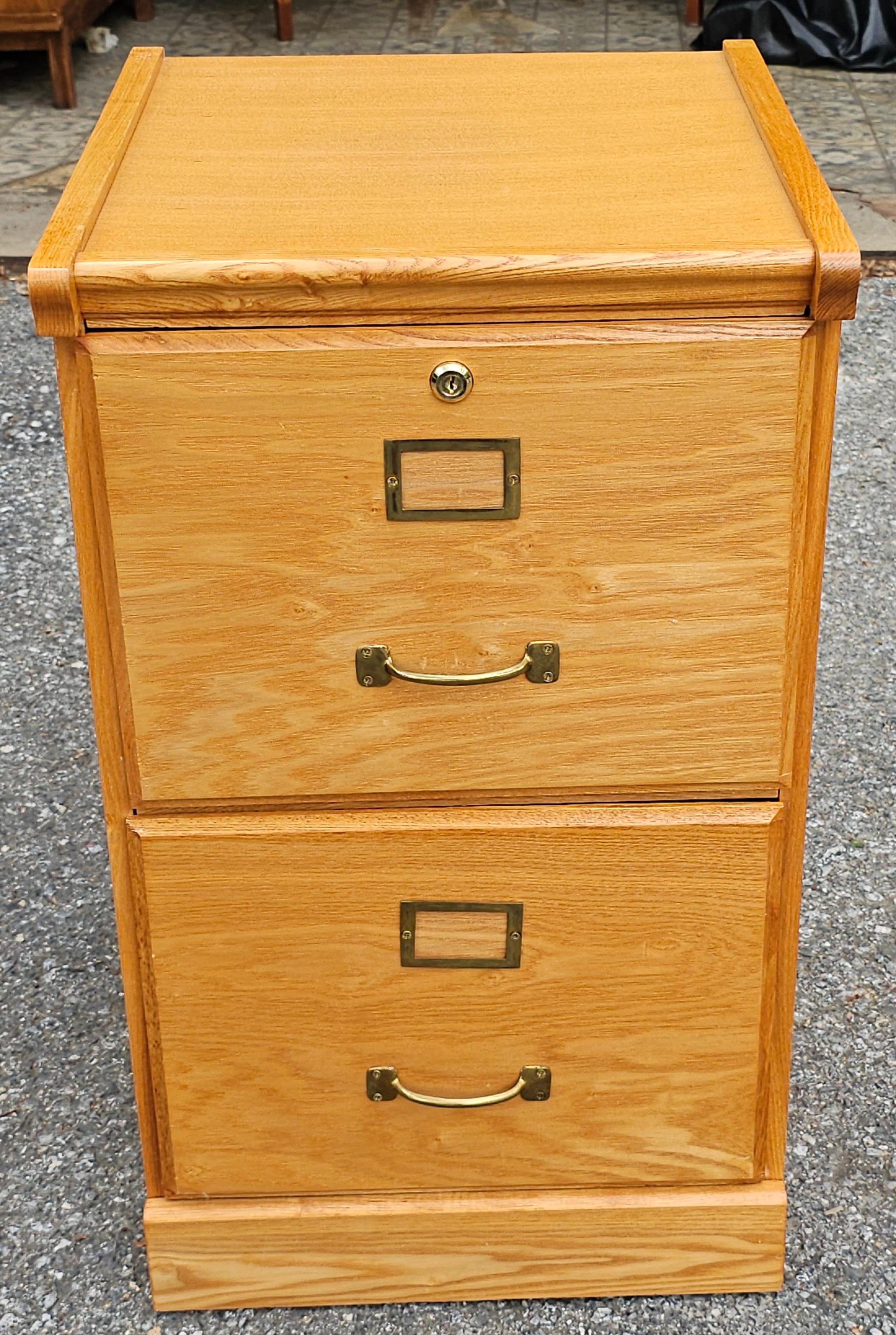 A Late 20th Century Oak Two-Drawer Letter Size Filing Cabinet with lock. Will hold legal size and letter size file folders. Come with two keys.
Measures 16