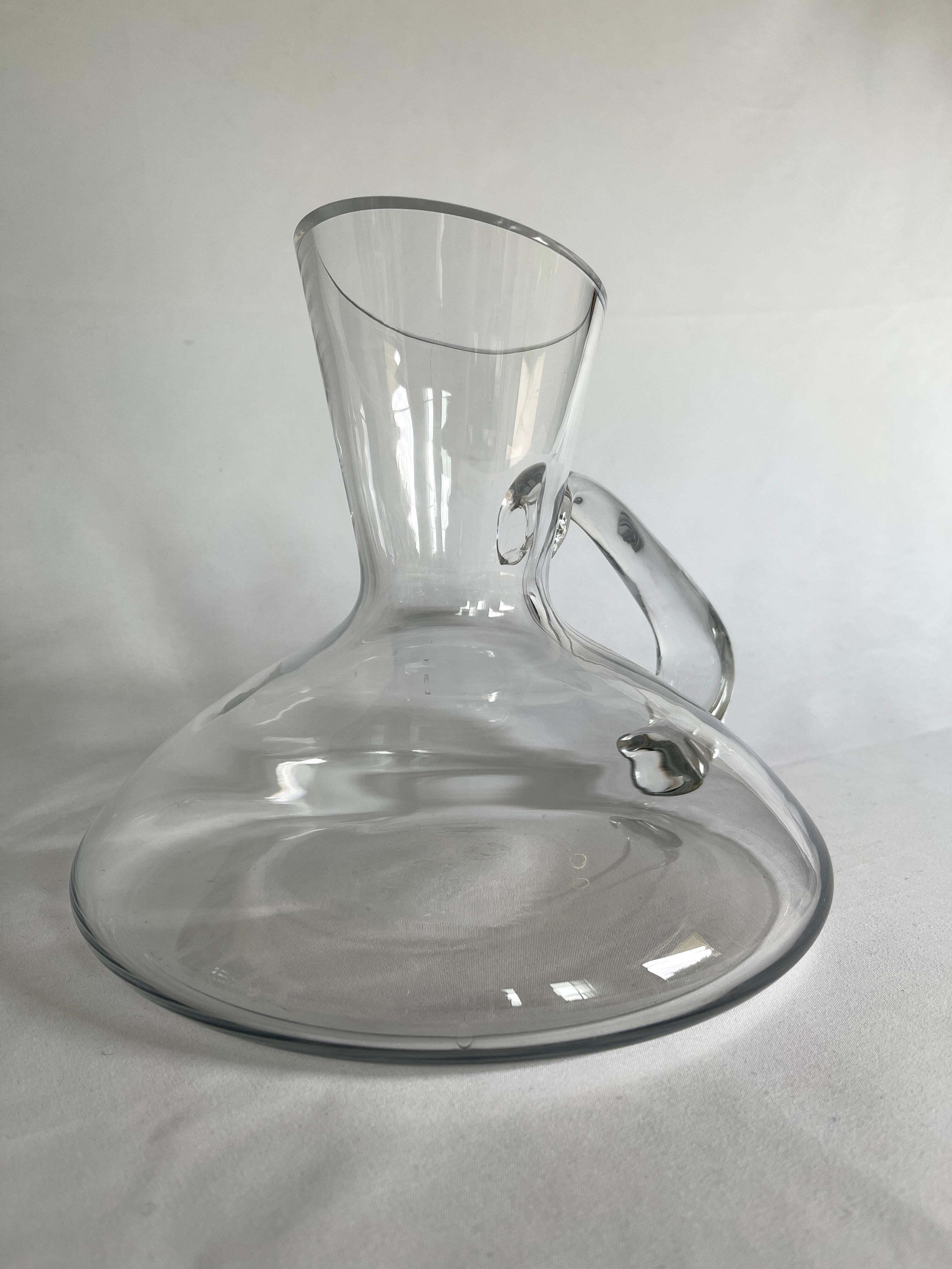 Graceful oblique form clear blown glass wine carafe / decanter with elegant handle.  
