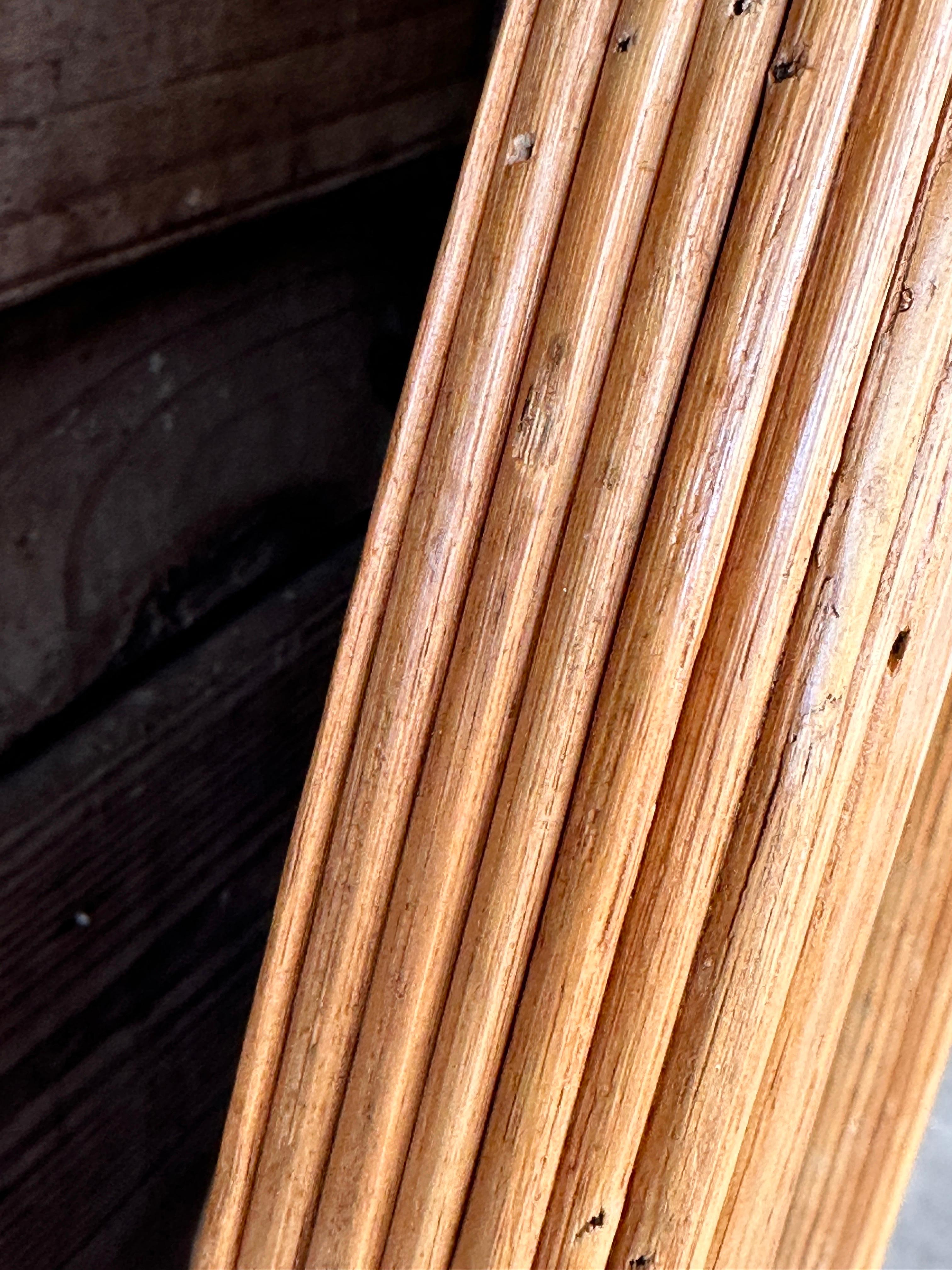 Here’s a description for the vintage pencil reed rattan oval mirror:

Beautiful vintage pencil reed rattan oval mirror, showcasing the timeless appeal of natural organic materials.
The frame has undergone some refinishing, enhancing its warm, earthy