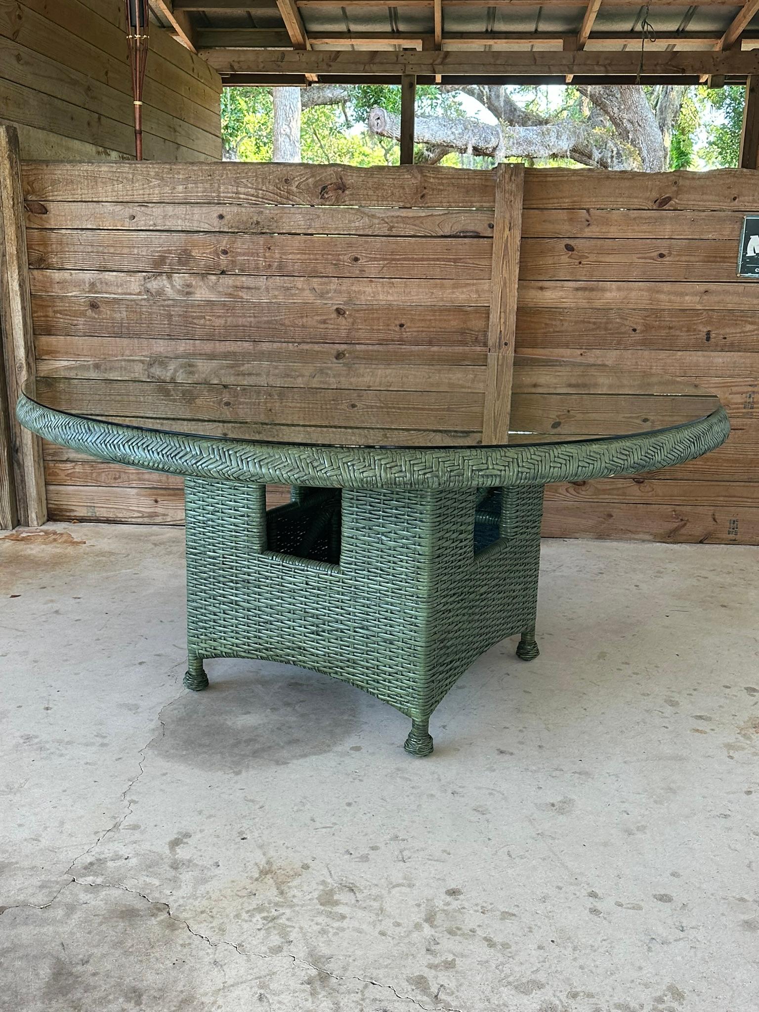 
Presenting a gorgeous, handcrafted rattan weave round pedestal dining table with a brand-new glass top by McGuire. This stunning piece is finished in its original deep jade green color, which showcases some wear, adding to its vintage charm and