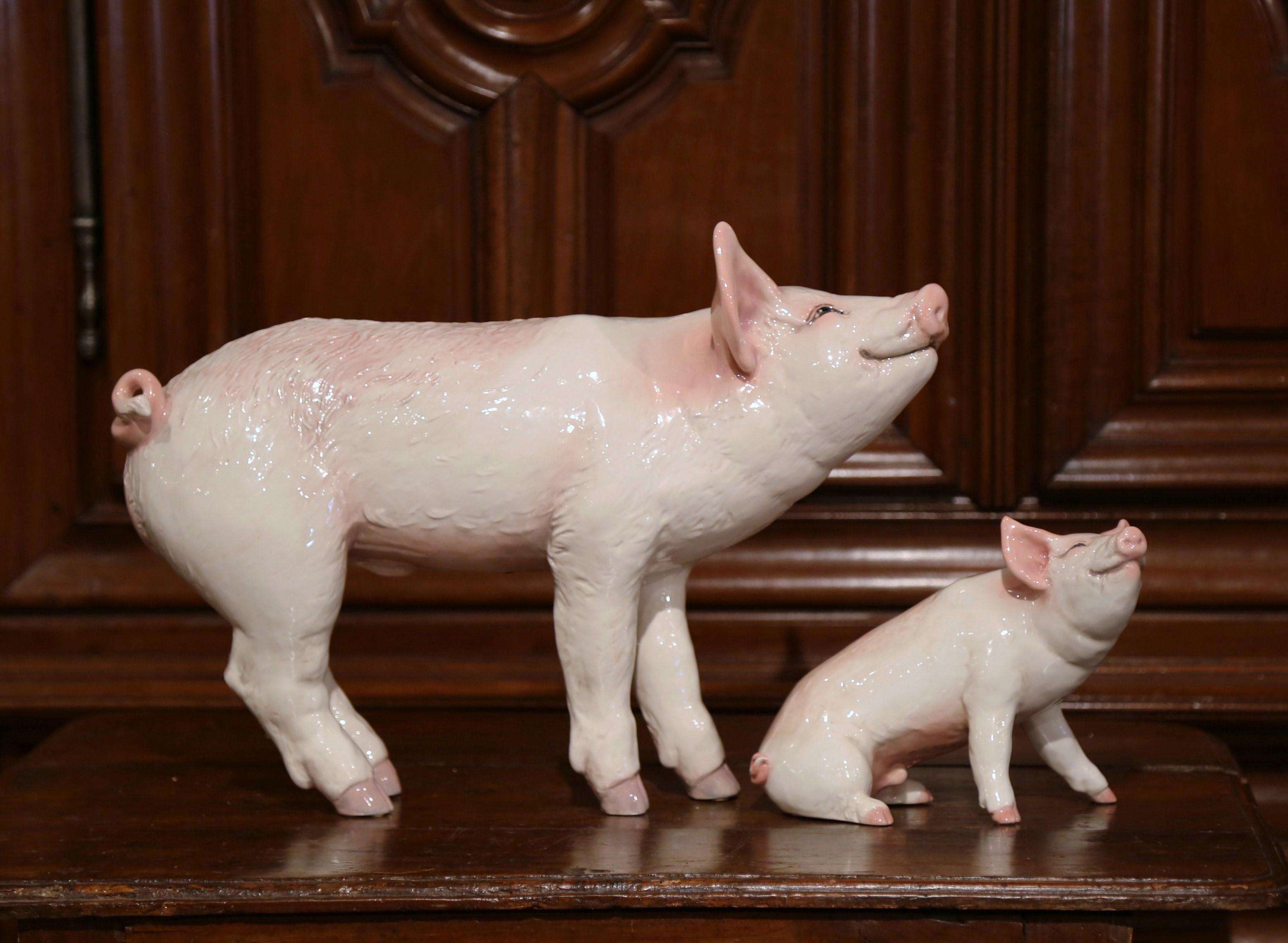 Decorate your kitchen counter with this superb set of sculptured, ceramic pigs. Crafted, circa 1980, the large pig and piglet figures are colorful, expressive, detailed, and realistic in shape and texture. The picturesque farm animals are in