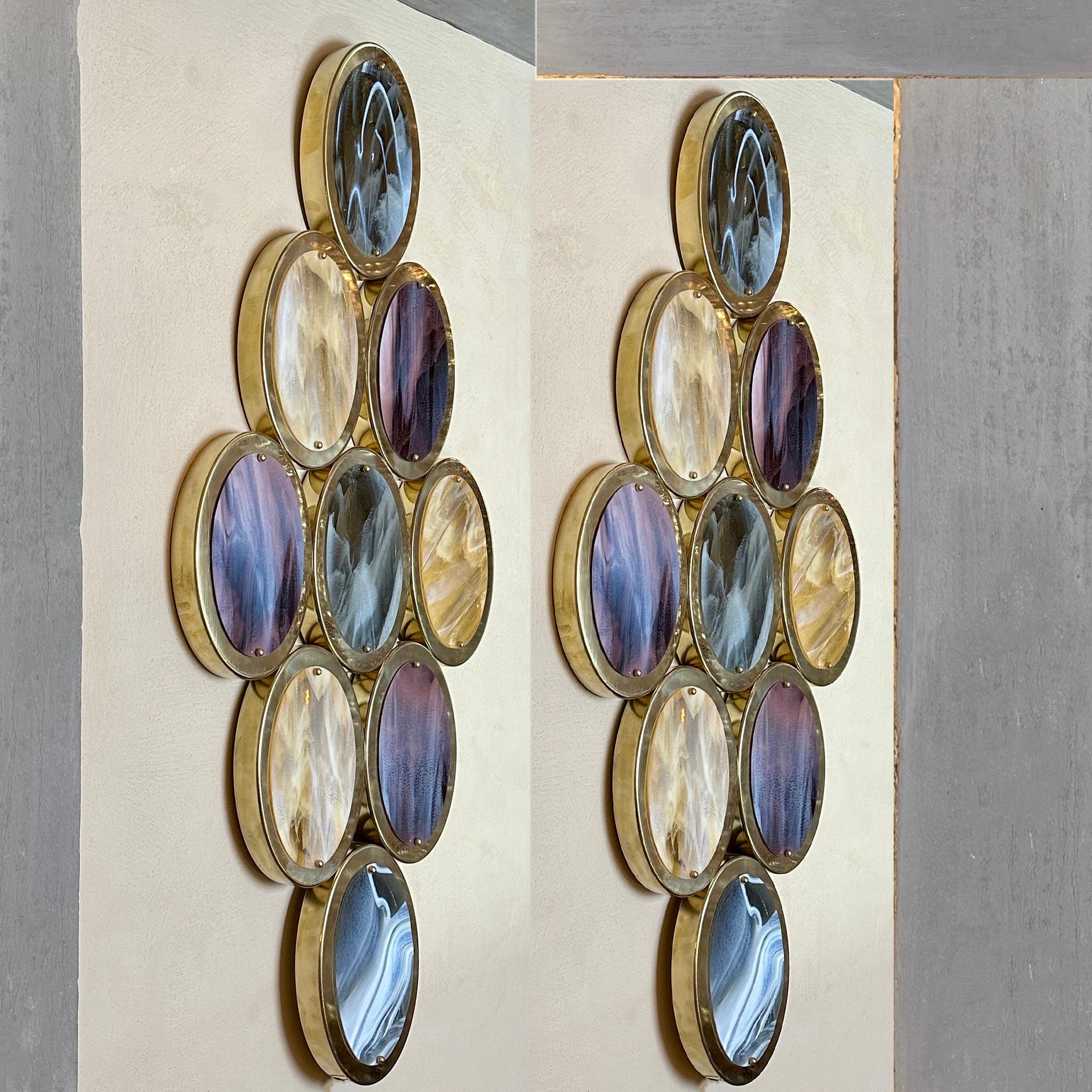 Impressive pair of brass & amber, grey and purple oval Murano Art glass sconces. A stunning true wall of light!
The oval glasses will be removed during transportation and each one is held into place with two brass screws.
9 E14 Light Bulbs each.