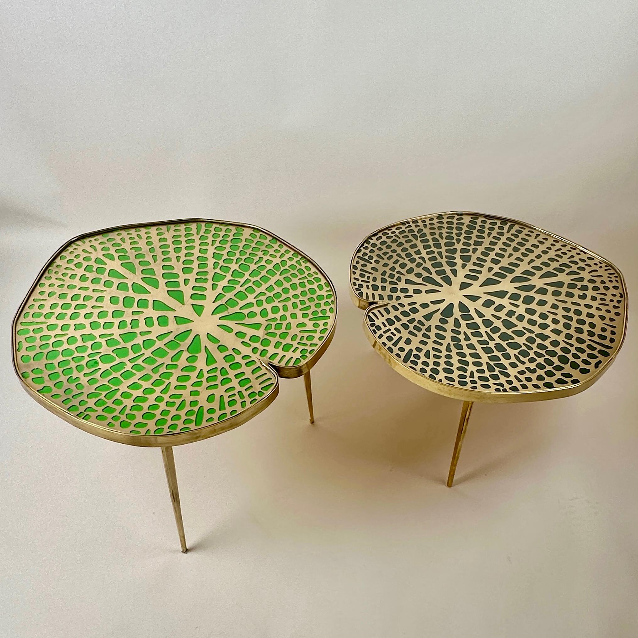 Pair of eclectic water lilies side tables / coffee tables with glass tops & leaf venation in gold metal underneath to create a small pond of beauty inside your living room.
The wood top under the gold metal venation of one table is painted moss
