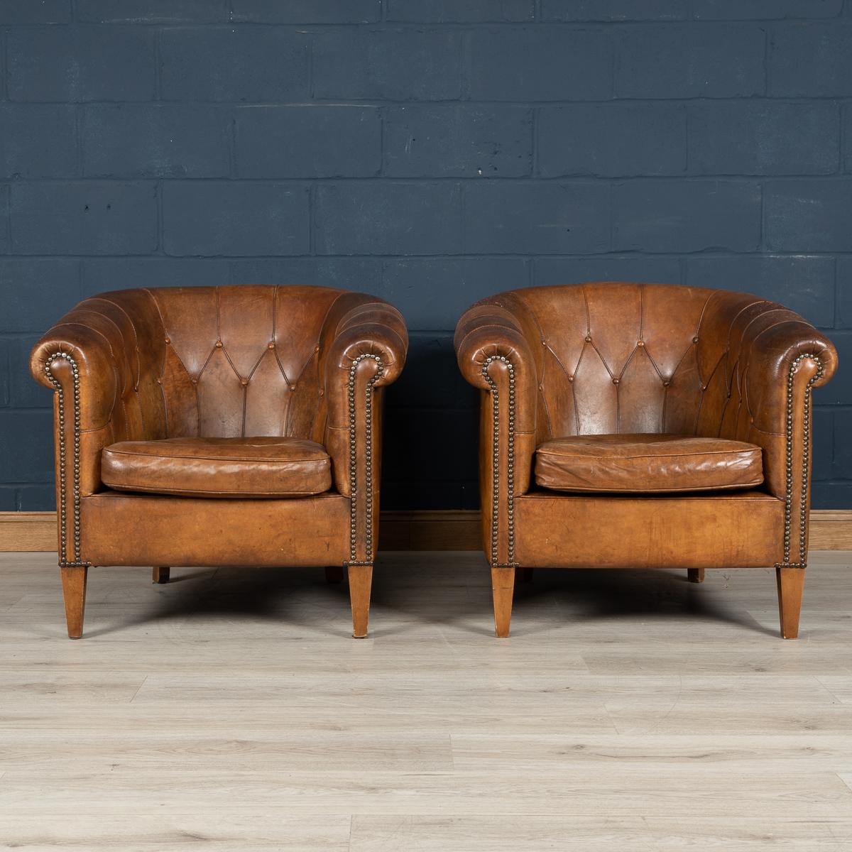 A wonderful pair of sheepskin leather tub chairs, mid-late 20th century, manufactured in Holland and of the finest quality with great patina. Lovely rich color, button back, very unusual model.

Please note that our interior pieces are located at