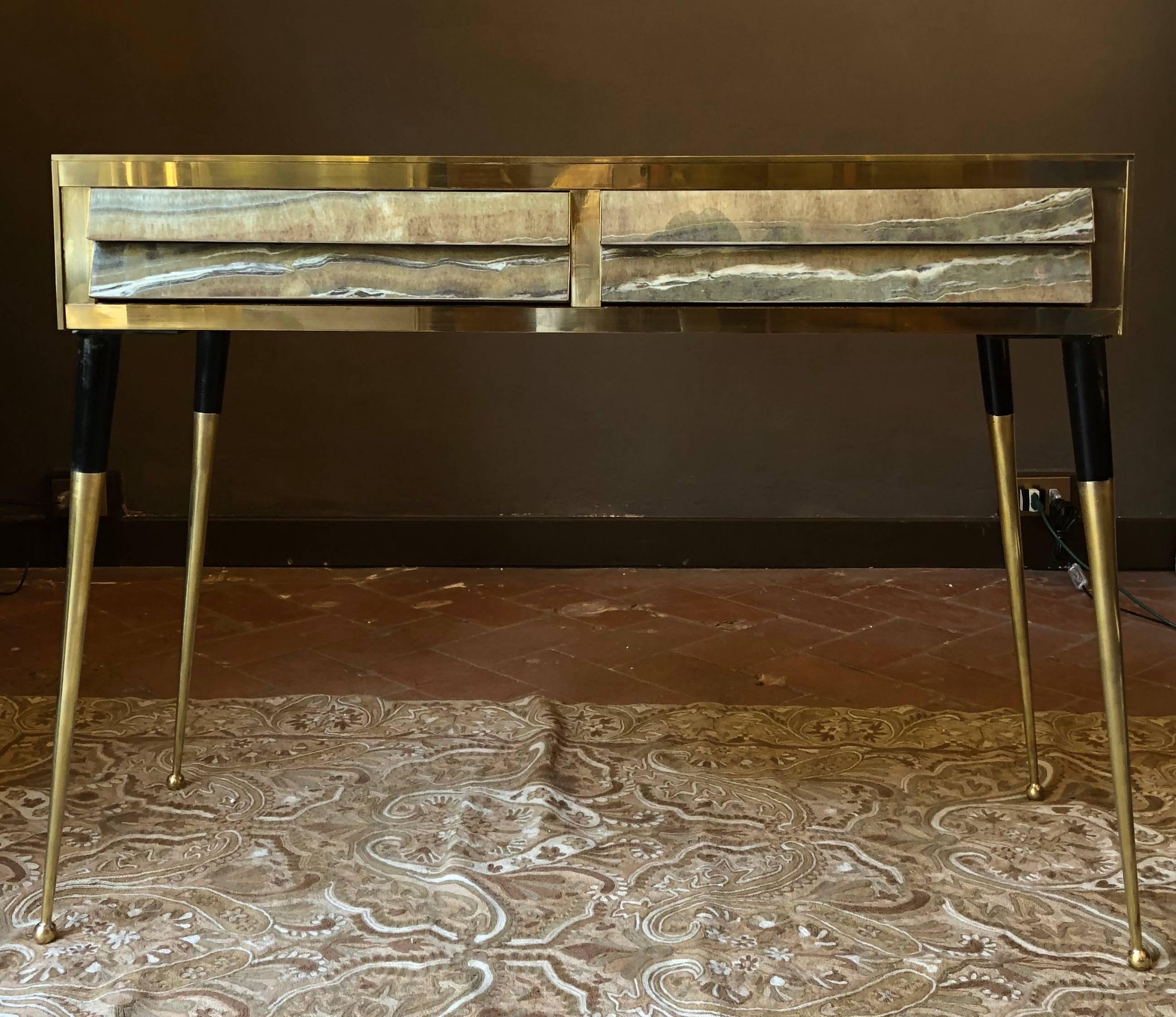 The pair of consoles is finished in the back and they can be used as dividers / centerpieces as well. 
Two drawers with grey velvet inside each piece. The first part of the brass legs are painted in black.
Legs can be taken off for an easier