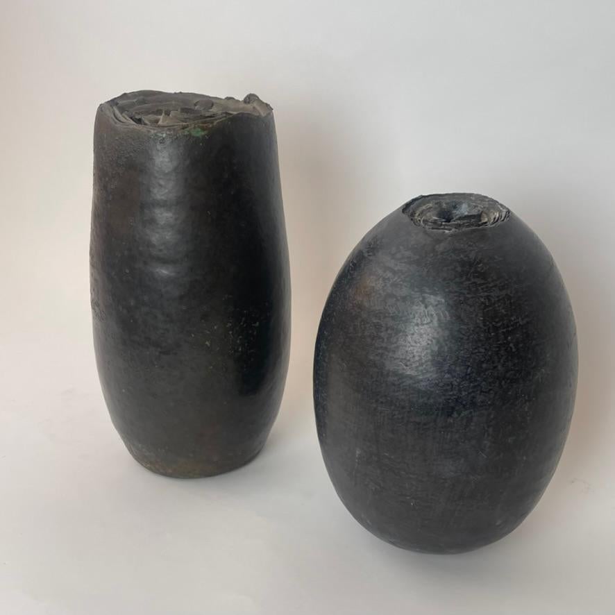 This pair of sculptural black stoneware vases of high visual impact is composed of two pieces of different sizes but made by the artist with the same technique. The shorter vase size is: 17 Diam. x 27 H cm.

Luca Leandri was born in Deruta in 1964