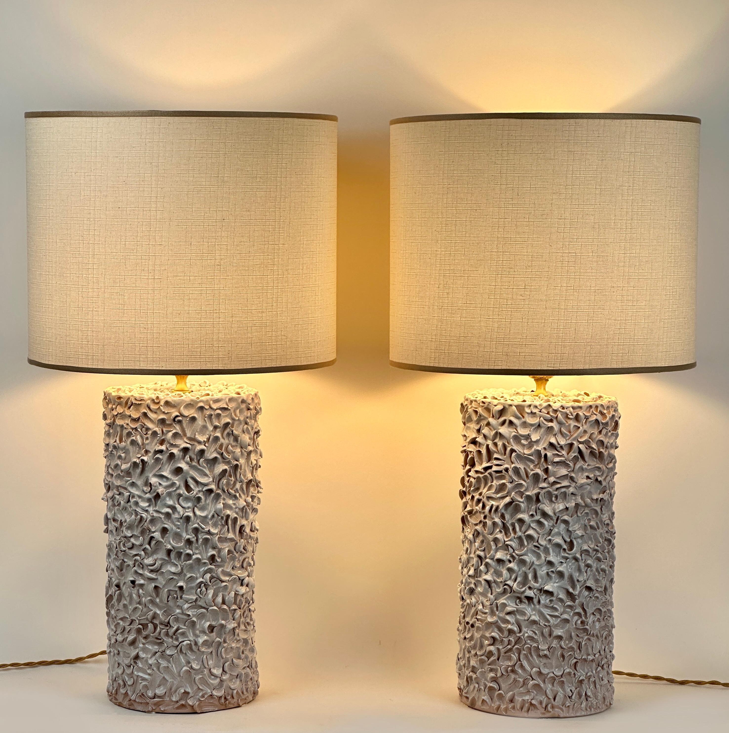 Interesting handmade textured pattern visible on the round ceramic bodies of the table lamps coming from the small town of Albisola Marina (Italian Riviera).
The white cotton shades size is: 40 Diam. x 32 H cm. each
The total lamp height with the