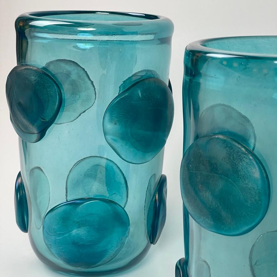Late 20th century pair of light blue iridescent Murano art glass vases with round matt Murano glass light blue applications.
Hand signed on the bottom.