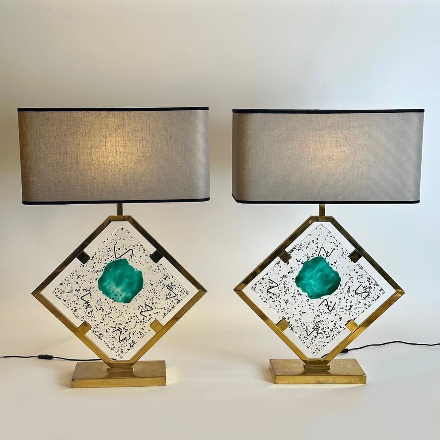The squared Murano art glass plaque has three colors inside: transparent, black & emerald green.
Price is including grey linen shades size: 60 x 30 x 30 H cm. each
Total lamp height with shade: 92 cm.
1 E27 light bulb each and italian plugs that