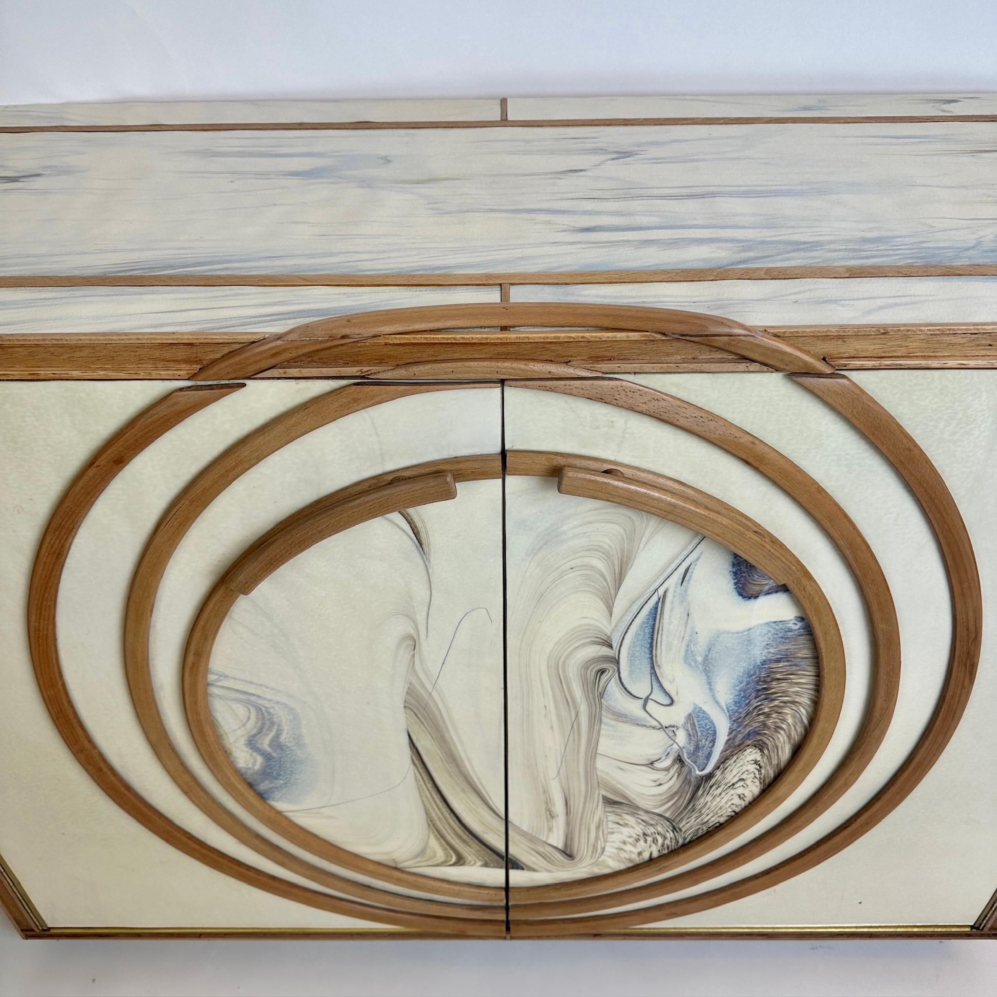 Magnificient pair of white textured Murano art glass (with touches of blue and brown) & beech wood with brass details cabinets. One central and removable wood shelf inside. Solid beech wood handles to pull open the two cabinet doors. All the wood