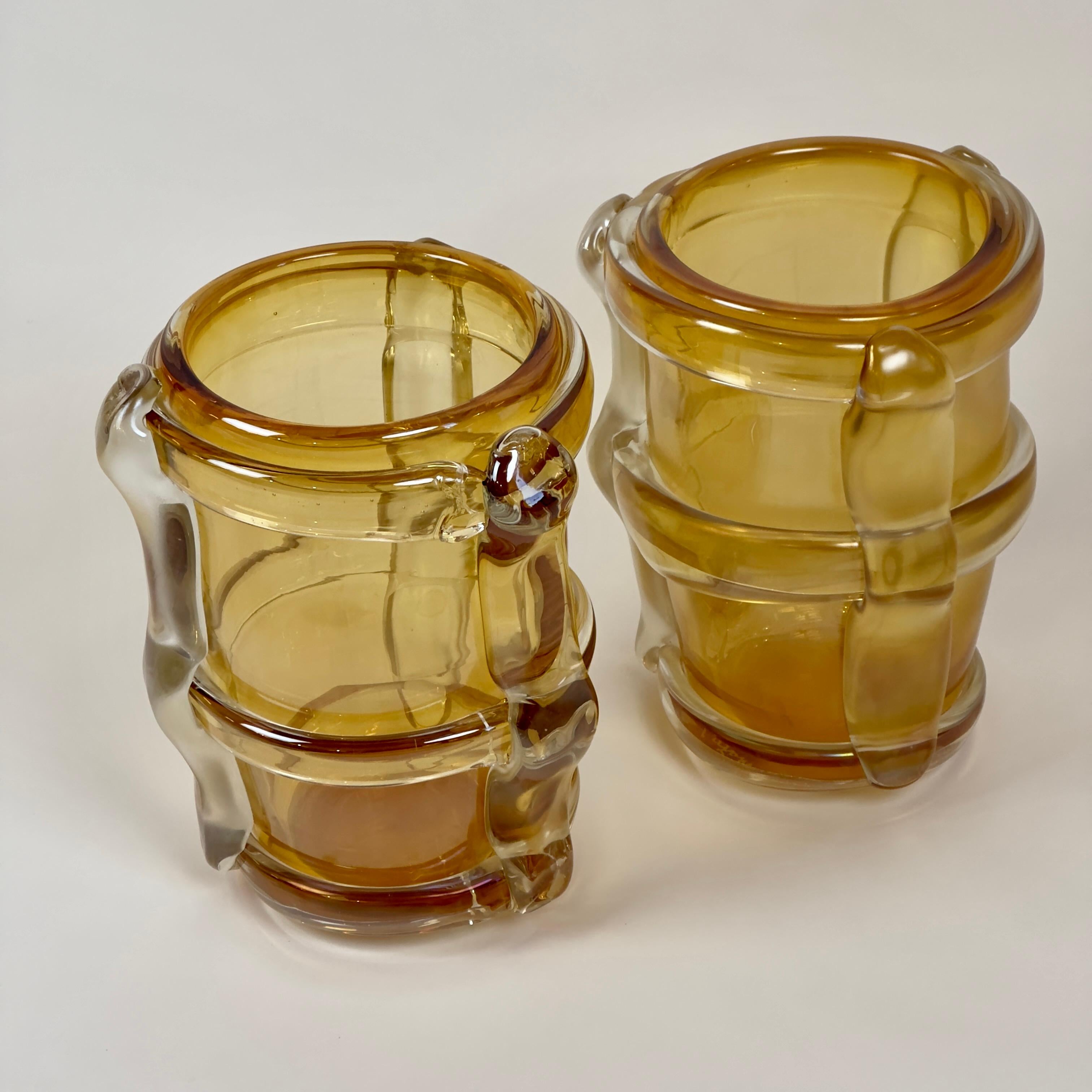 Late 20th century pair of yellow Murano art glass vases with transparent & matt Murano glass yellow applications. 
One vase has been done on purpose more transparent than the other one. Hince, one vase has a transparent clear finish while the other