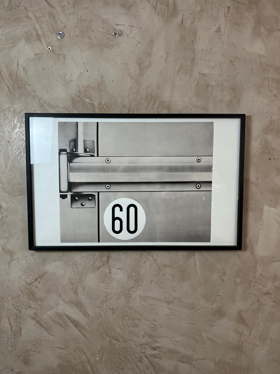 Add a touch of originality to your interior with this black and white framed screen print by Peter Klasen, featuring a sleek, industrial design. The image showcases a mechanical detail, subtly structured, with the number 